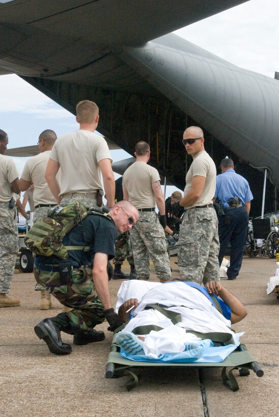 U. S. Air Force unit members from the 136th Airlift Wing, Texas Air National Guard, Fort Worth and U.S. Army soldier from AH33FA Nacogdoches, TX prepare to carry a special needs person awaiting to airlift to safety at the SE Texas Regional Airport, Beaumont , Texas, in support of Hurricane Ike relief efforts, 11 September 2008. (Photo by Staff Sgt Jennifer Marrs)