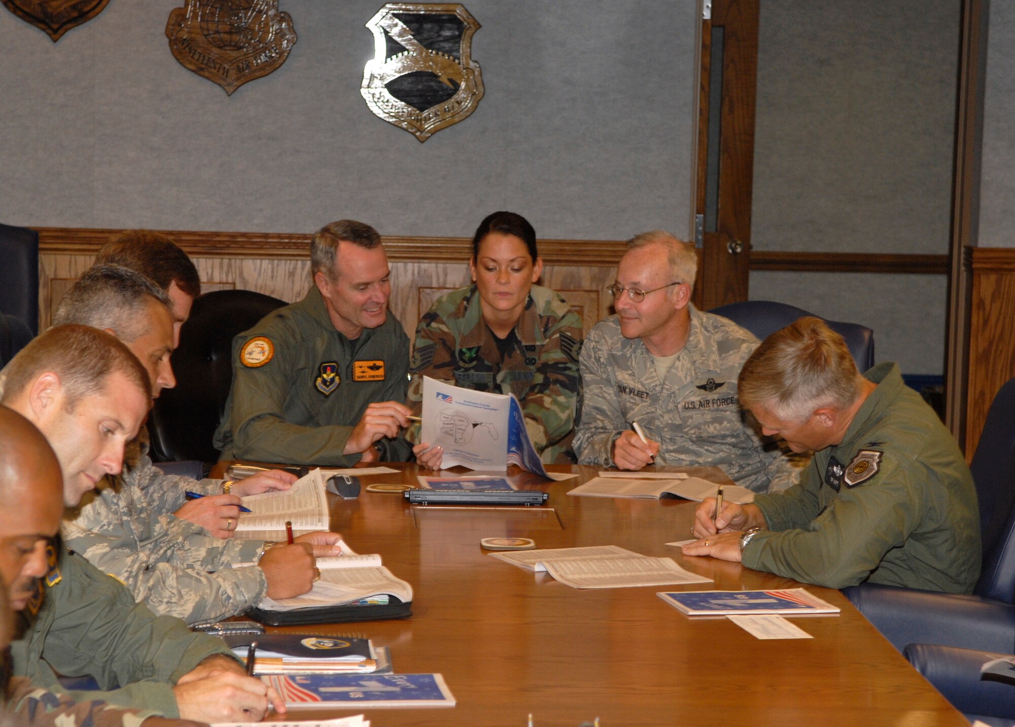 The 2008 Combined Federal Campaign, a fundraising effort for more than 1,200 charitable organizations, began Sept. 15 at Tyndall Air Force Base. The 325th Fighter Wing commander, Brig. Gen. Darryl Roberson, and 325th Fighter Wing command chief, Chief Master Sgt. Benjamin Van Vleet, complete their CFC pledge cards with other Tyndall group and squadron commanders. Tyndall’s overall base goal is 198,325 dollars. (Photo by Lisa Norman)