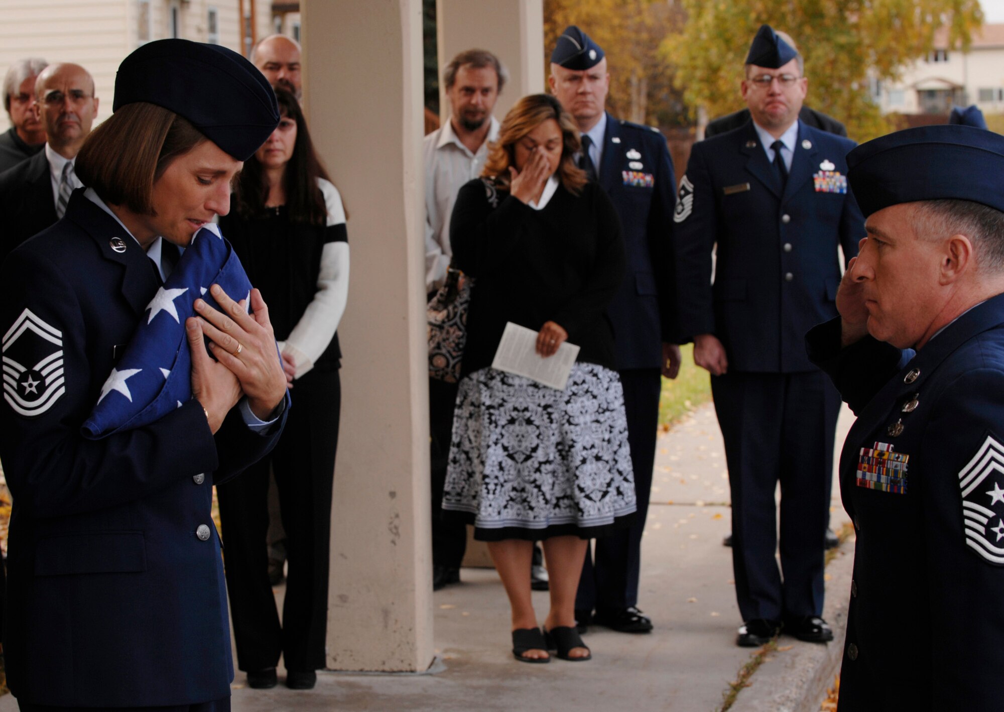 354th Fighter Wing Command Chief, Chief Master Sgt. Earl Hannon, salutes the flag that he presented to Senior Master Sgt. Angela Young during the Sept. 13, 2008, memorial service for her late husband, Chief Master Sgt. James A. Young.  Chief Young passed away Sept. 6, 2008.

(U.S Air Force photo by Tech Sgt. Eric T. Sheler)
