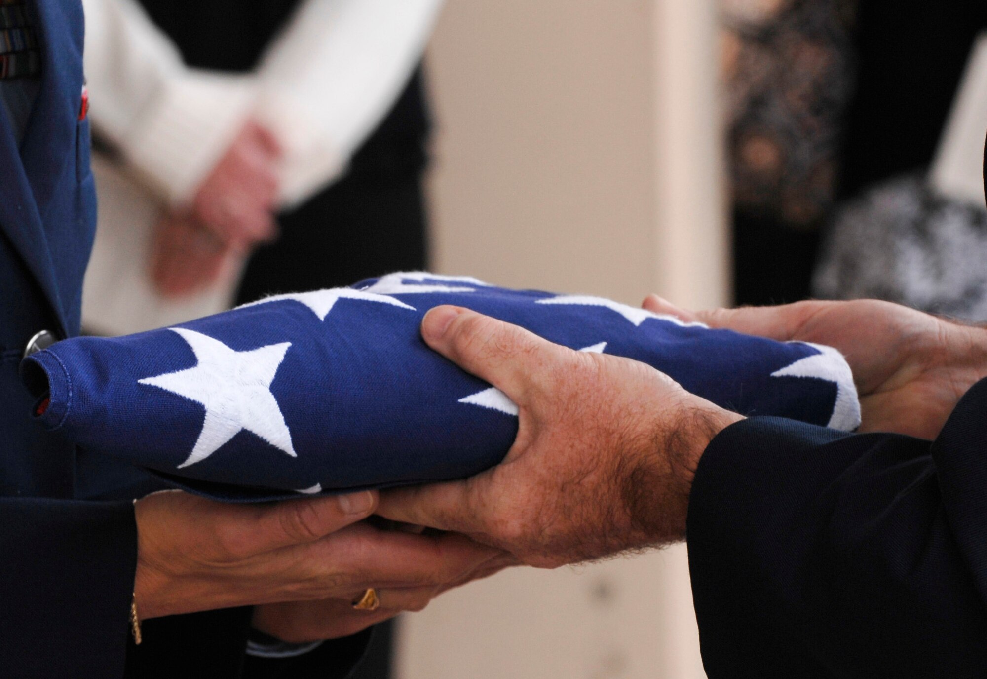 The American Flag is presented to Senior Master Sgt. Angela Young from 354th Fighter Wing Command Chief, Chief Master Sgt. Earl Hannon during the Sept. 13, 2008, memorial service for her late husband, Chief Master Sgt. James A. Young.  Chief Young passed away Sept. 6, 2008.

(U.S Air Force photo by Tech Sgt. Eric T. Sheler)
