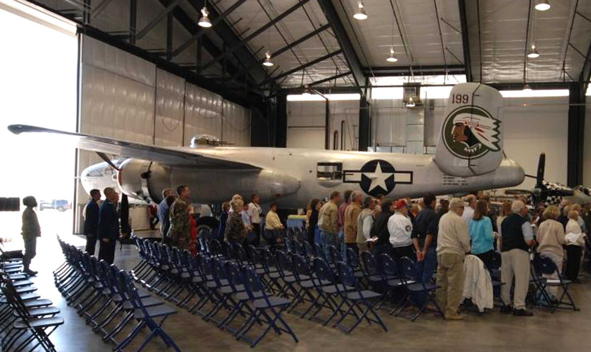 Attendees stand under the wings of the B-25J Mitchell “In The Mood” and in front of an airworthy P-47 Thunderbolt during the 380th Space Control Squadron’s activation ceremony Sept. 6 in Colorado Springs, Colo. During the ceremony, Lt. Col. Michael Assid accepted command of the squadron from Col. Jeffrey Ansted. The squadron was re-activated from it's original World War II-era mission of bombers to take on the Air Force Reserve mission of space control. Colonel Assid becomes the squadron's 27th commander during its ongoing lineage. Colonel Ansted is the 310th Space Wing commander. (Courtesy photo/Rollan Yocum)
