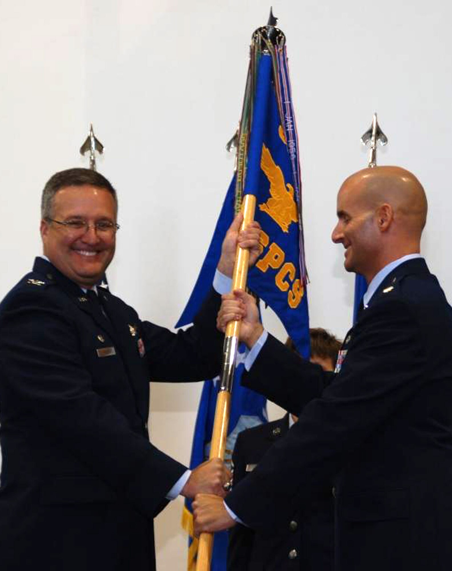 Lt. Col. Michael Assid (right) accepts command of the 380th Space Control Squadron from Col. Jeffrey Ansted during the unit's re-activation ceremony Sept. 6 in Colorado Springs, Colo. The squadron was re-activated from it's original World War II-era mission of bombers to take on the Air Force Reserve mission of space control. Colonel Assid becomes the squadron's 27th commander during its ongoing lineage. Colonel Ansted is the 310th Space Wing commander. (Courtesy photo/Rollan Yocum)