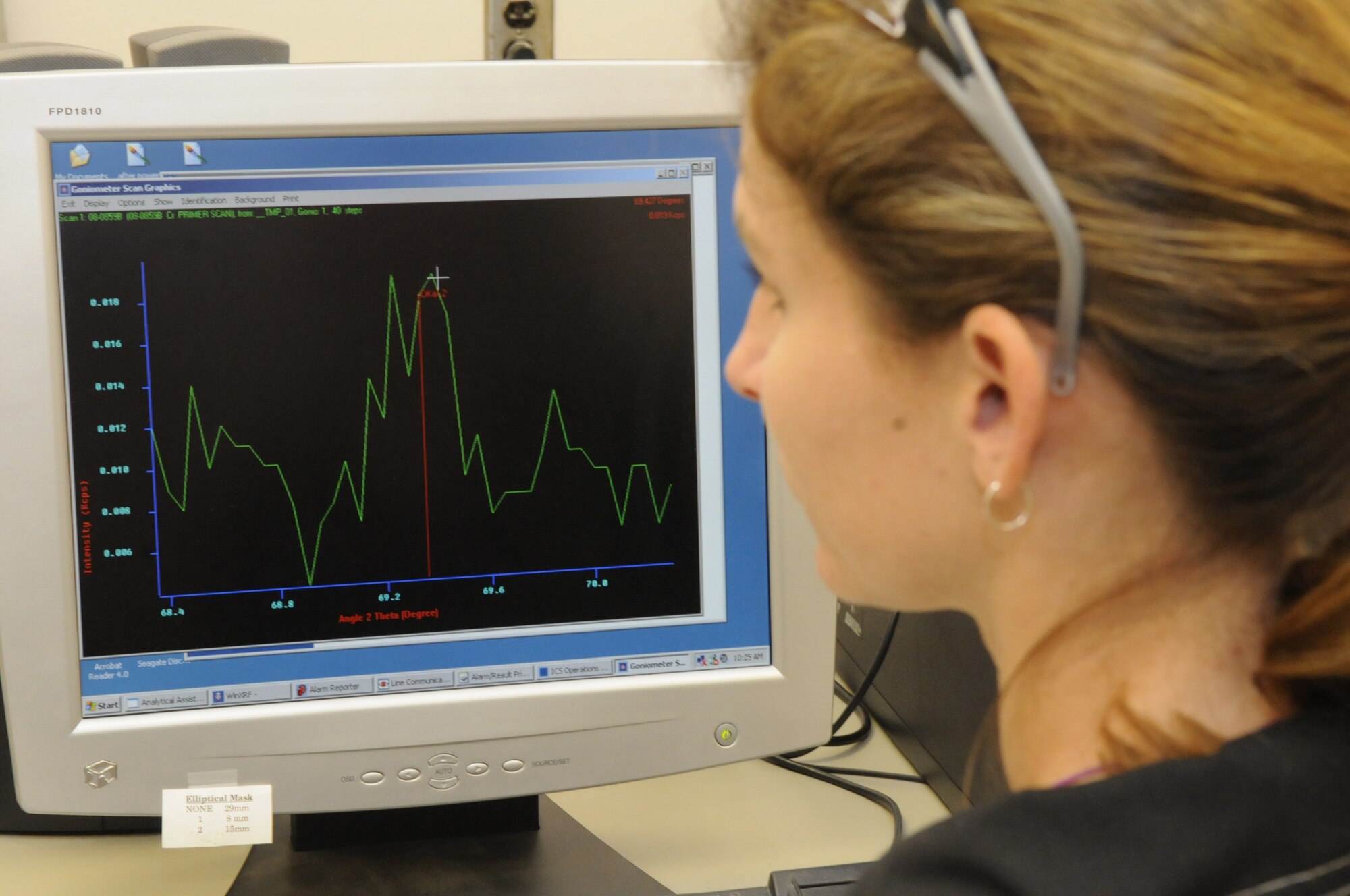 Laura Abbott, chemist, gets a result on the computer screen of  an X-ray fluorescence spectrometer that determines concentrations of lead and other heavy metals in paints and other materials. U. S. Air Force photo by Sue Sapp