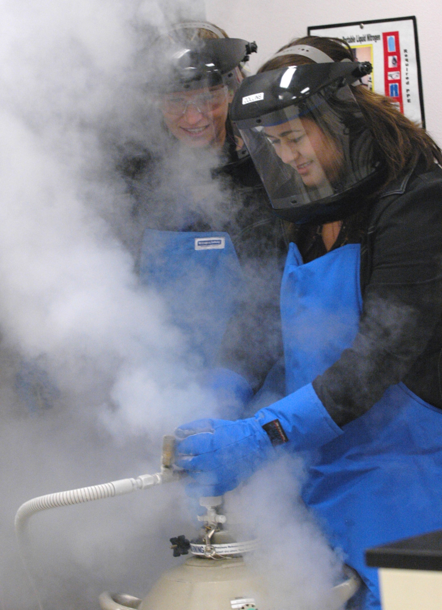 Laura Abbott and Della Smith, perform a liquid nitrogen pressure transfer to a dewar for use in cooling various laboratory instrumentation. U. S. Air Force photo by Sue Sapp