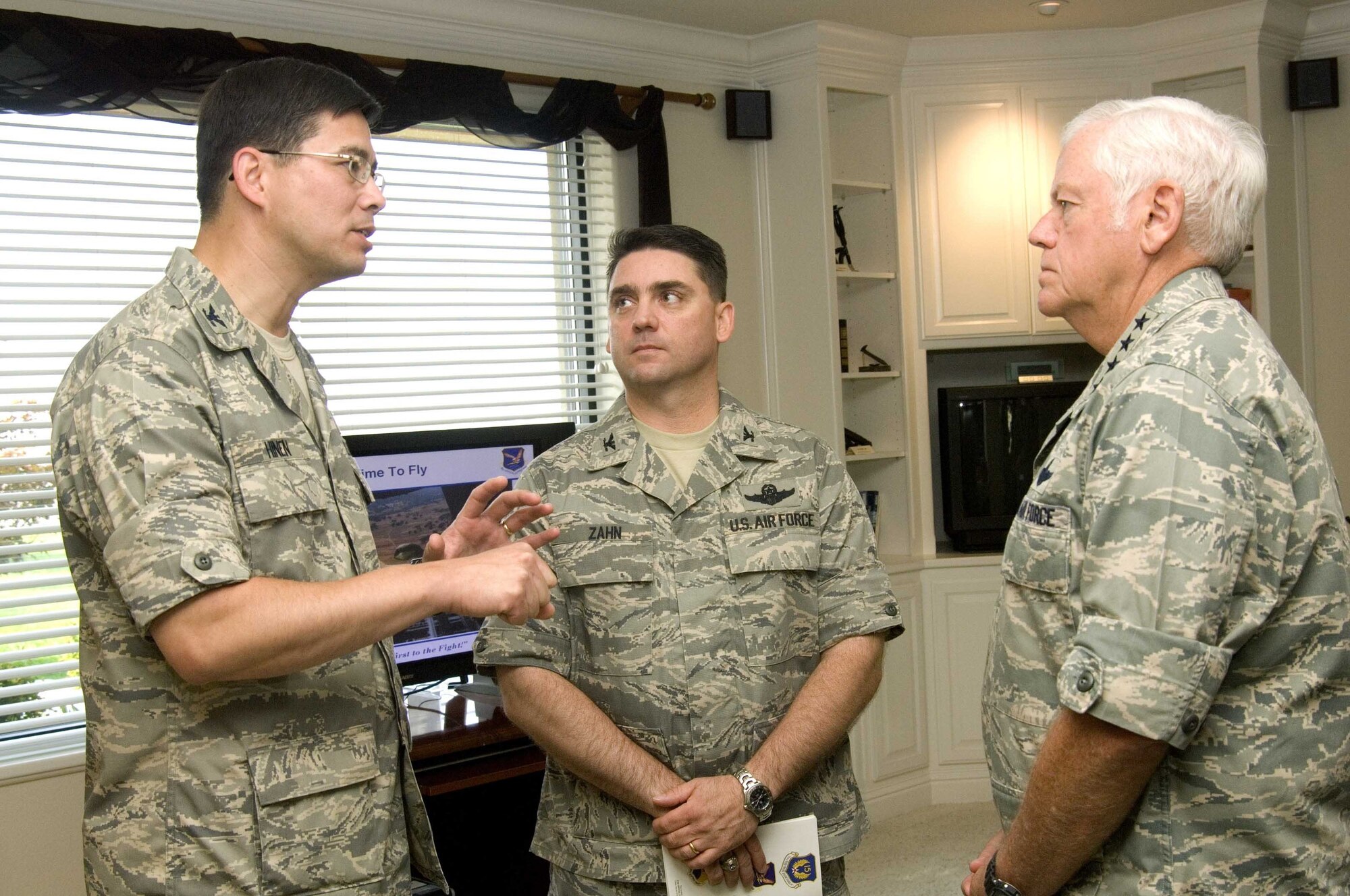 Col. Tony Hinen, 615th Contingency Response Wing commander speaks with Gen. Arthur Lichte, commander Air Mobility Command, and Col. Joseph Zahn, 615th CRW vice commander, during the general's visit to Travis recently. Colonel Hinen will retire after relinquishing command of the 615th CRW Sept. 23.(U.S. Air Force photo/Dave Cushman)
