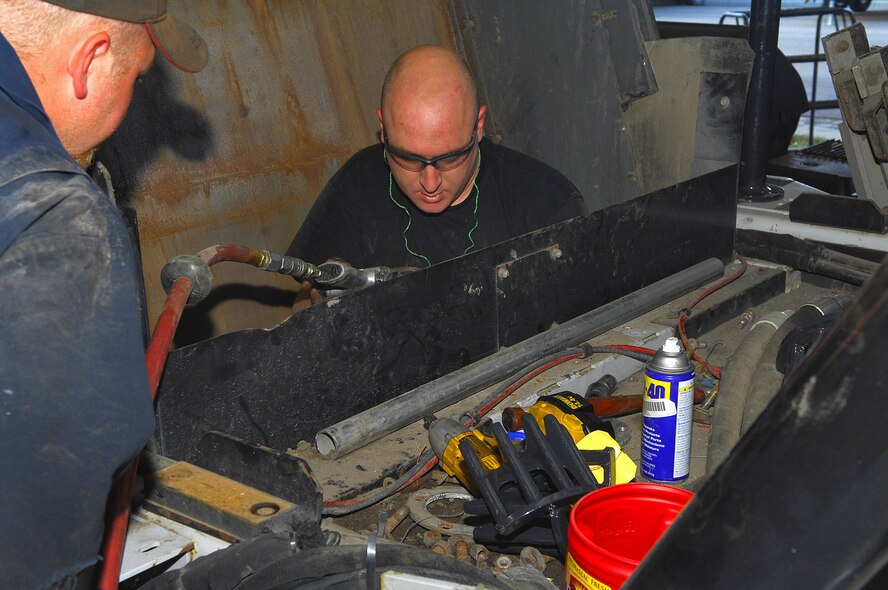 MINOT AIR FORCE BASE, N.D. -- Staff Sgt. Brett Whitish, 5th Logistics Readiness Squadron vehicle maintenance assistant noncommissioned officer-in-charge, rebuilds a hopper assembly on a street sweeper here Sept. 17 in preparation for the upcoming winter months. Street cleaning is one of many mission-essential capabilities the 5th LRS provides Minot AFB. (U.S. Air Force photo by Airman 1st Class Benjamin Stratton)