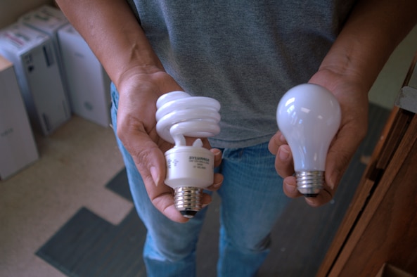 CANNON AIR FORCE BASE, N.M. -- New energy-efficient light bulbs, such as the one on the left, are being installed throughout base housing as part of Operation Change Out. Cannon's goal is to replace 1,053 inefficient bulbs that will save $64,543 and reduce carbon dioxide emissions. Operation Change Out is a joint energy-saving and enviornmental program between the Departments of Defense and Energy. (Air Force photo by Greg Allen)