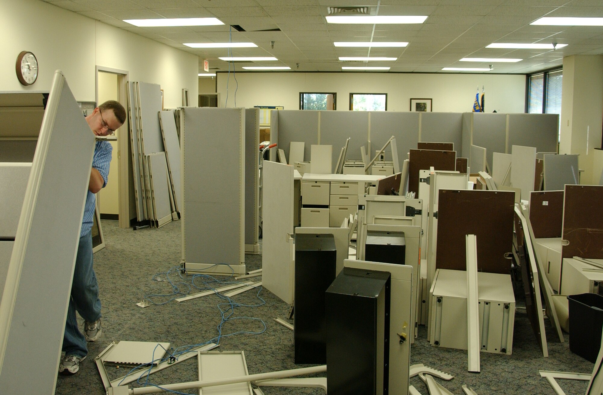 Contractor Brian Bourn moves a filing cabinet during a furniture reconfiguration of the 71st Comptroller Squadron. Due to this project, finance customer service is closed Sept. 18-19. (U.S. Air Force photo by Staff Sgt. Brian Hill)
