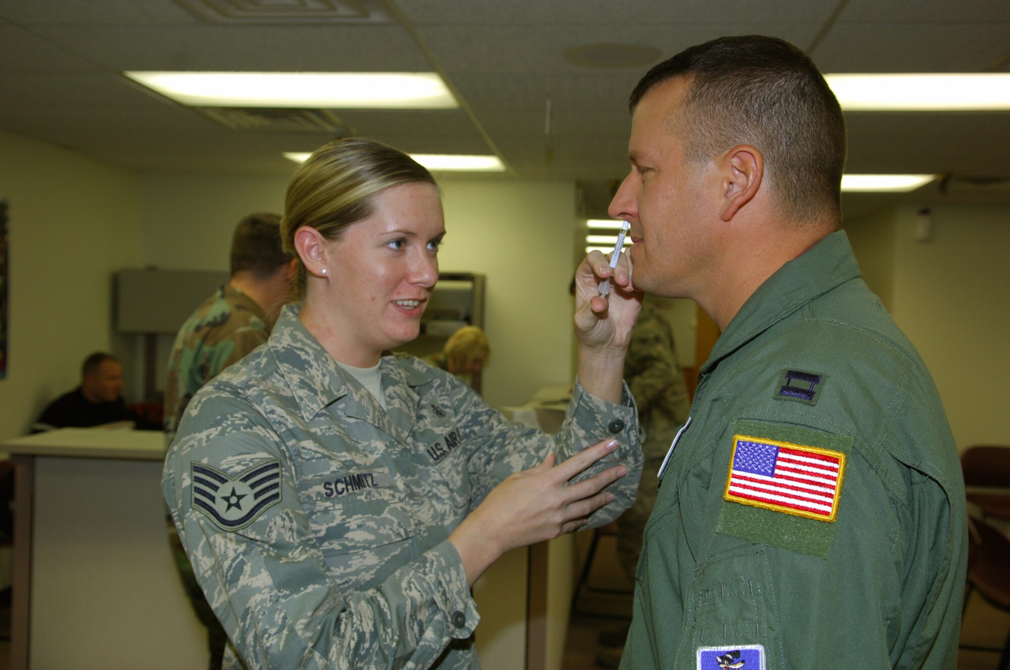 MINOT AIR FORCE BASE, N.D. – Staff Sgt. Erin Schmitz, 5th Medical Operations Squadron medical technician, administers a flu vaccination to Capt. Eric Doctor, 91st Missile Wing chief of programs and logistics, here Sept. 16. Flu vaccinations are currently being administered to Minot AFB Airmen, and are scheduled to be available for dependents in late October or early November. (U.S. Air Force photo by Senior Airman Cassandra Jones)