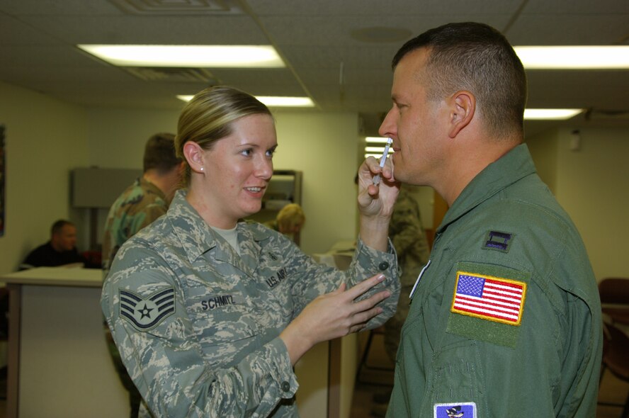 MINOT AIR FORCE BASE, N.D. – Staff Sgt. Erin Schmitz, 5th Medical Operations Squadron medical technician, administers a flu vaccination to Capt. Eric Doctor, 91st Missile Wing chief of programs and logistics, here Sept. 16. Flu vaccinations are currently being administered to Minot AFB Airmen, and are scheduled to be available for dependents in late October or early November. (U.S. Air Force photo by Senior Airman Cassandra Jones)