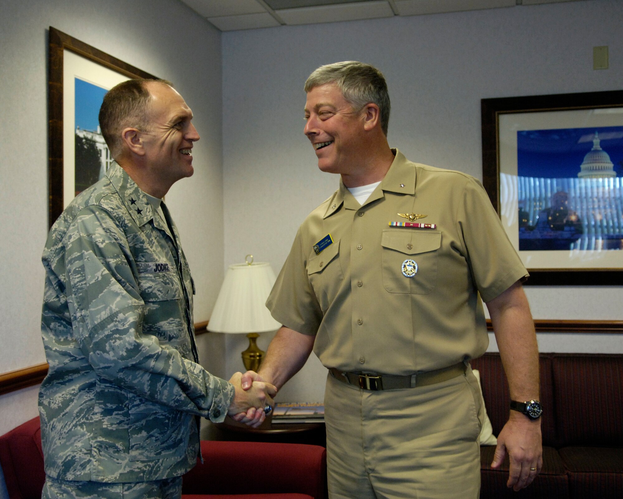 Maj. Gen. Ralph Jodice II, Air Force District of Washington commander, greets Navy Rear Adm. Patrick J. Lorge, commandant, Naval District of Washington, on his arrival to the general’s office Sept. 18. This is the first official meeting between the two component commanders, who have specific service roles in the National Capital Region and shared responsibilities as leaders of their respective commands in the Joint Forces Headquarters-NCR. (U.S. Air Force photo by Senior Airman Renae L. Kleckner)
