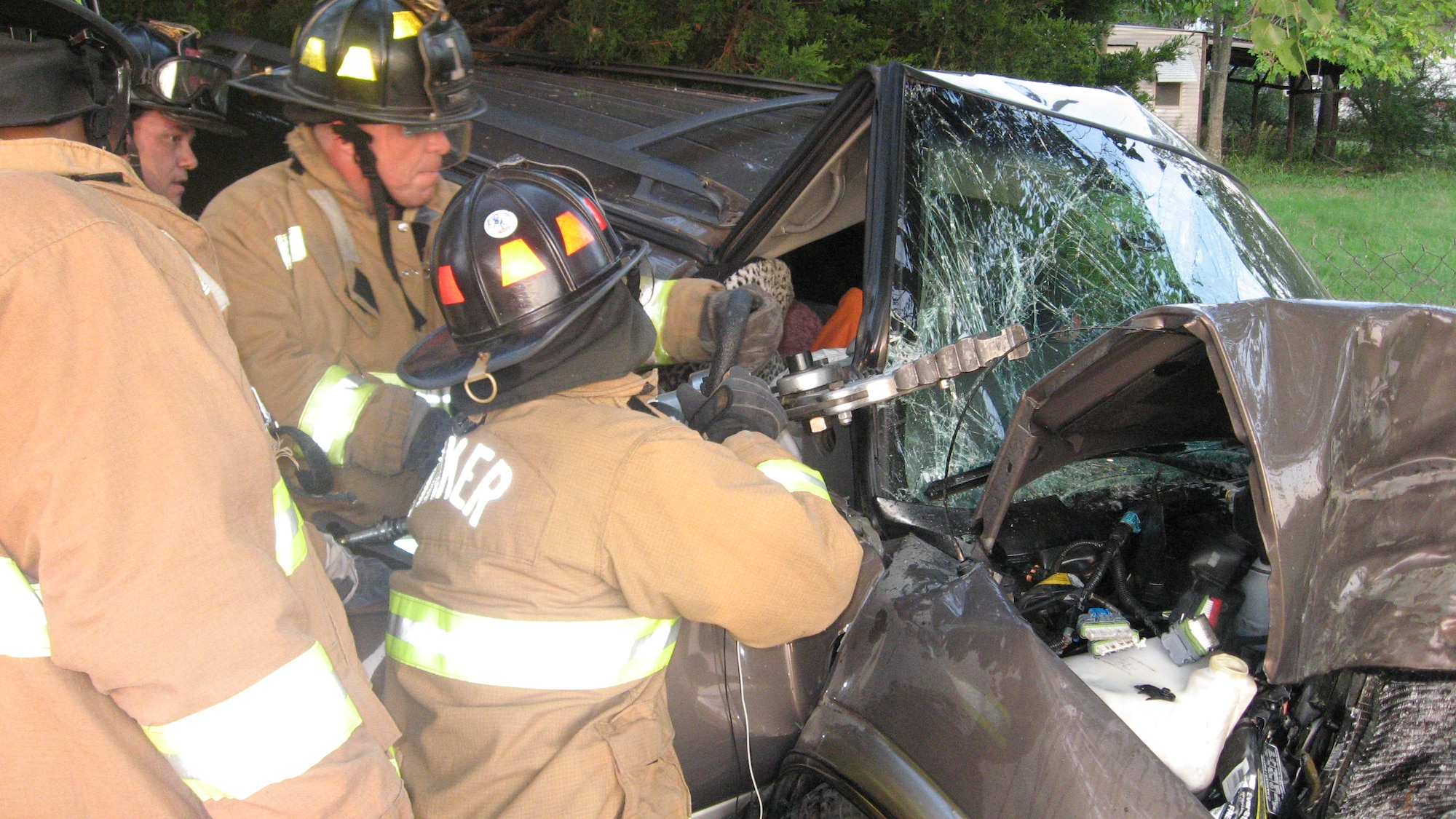 Tinker firefighers use the jaws of life to remove an accident victim from a car on Douglas Boulevard near the Lancer Gate. Tinker’s emergency services routinely assist responders from the surrounding area in mutual aid situations. (Courtesy photo)