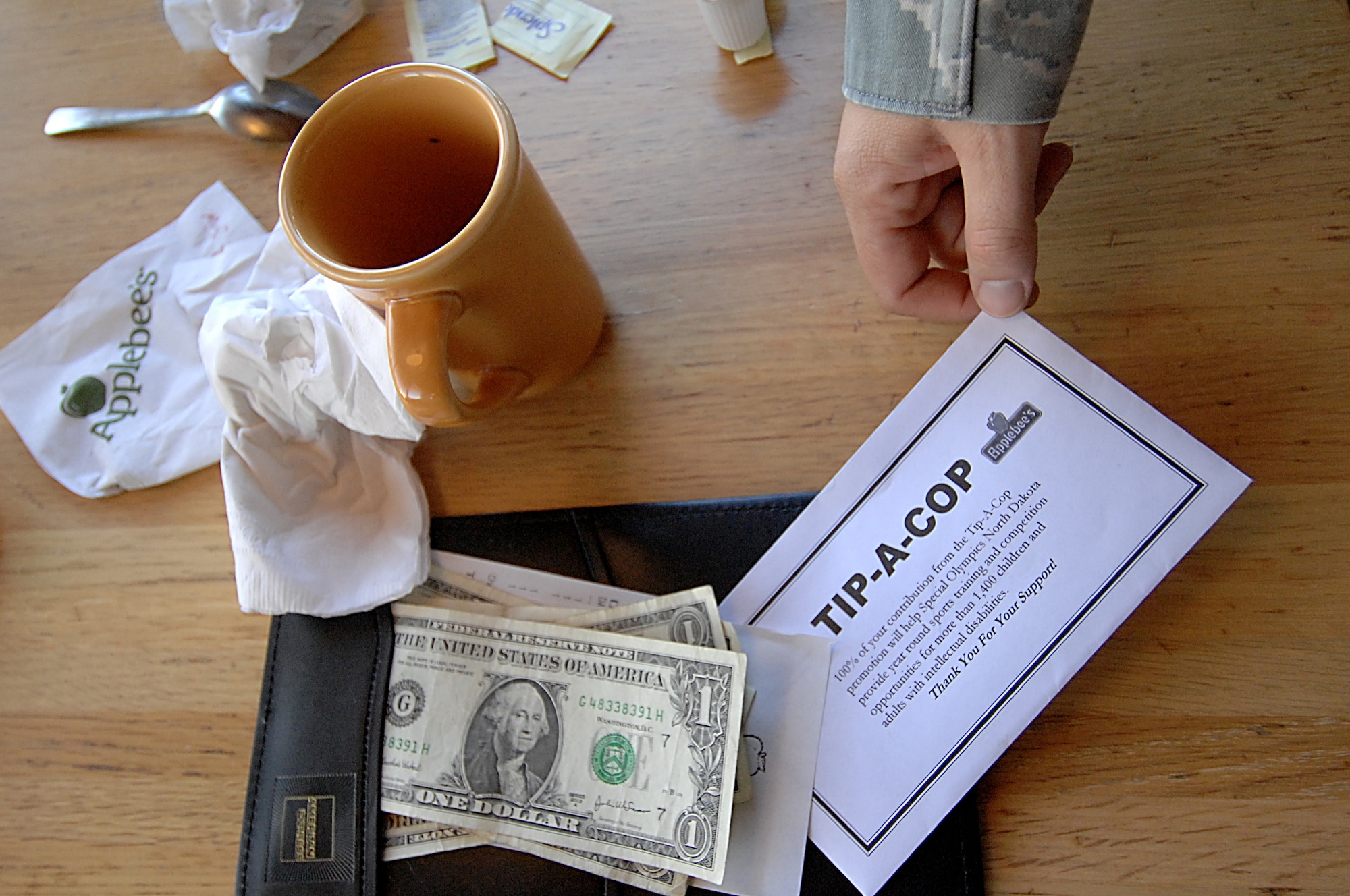 MINOT, N.D. – Members of local Minot law enforcement agencies, including Airmen from the 5th Security Forces Squadron at Minot Air Force Base, raised money for the Special Olympics through a national fundraising program called “Tip-a-Cop” at the Minot Applebee’s Restaurant here Sept. 15. The goal of the “Tip-a-Cop” program is for law enforcement officers to collect as many “tips” or donations as possible for Special Olympics. (U.S. Air Force photo by Senior Airman Kelly Timney)