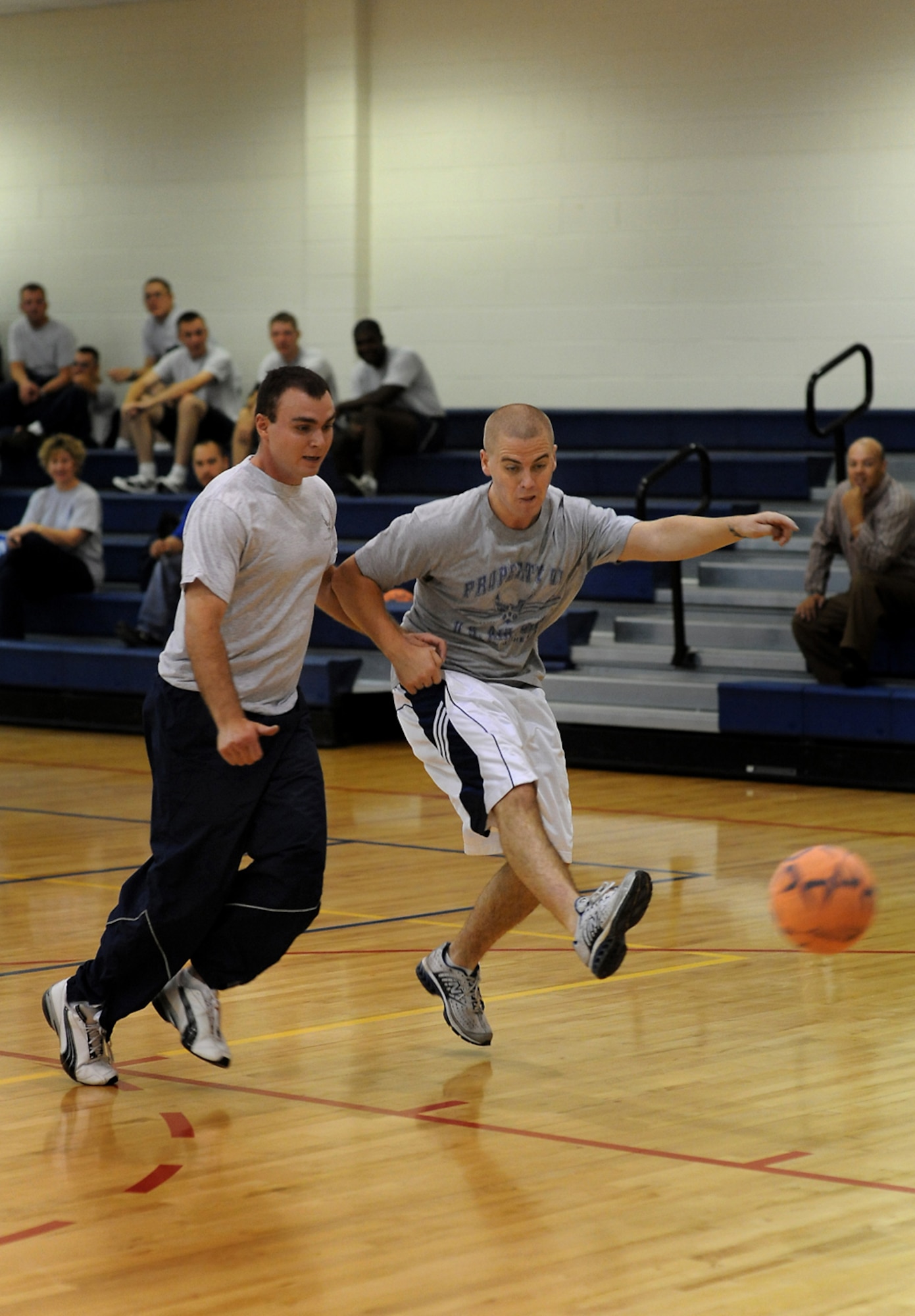 BUCKLEY AIR FORCE BASE, Colo. -- Nathan Smith, 460th CPTS, kicks the ball past a defender during an indoor soccer game at the Team Buckley Sports and Field Day, Sept. 12, at the Fitness Center during the Team Buckley Sports and Field Day. Events were originally scheduled to take place outside, but inclement weather forced sports day inside. Indoor soccer was played in place of ultimate frisbee. (U.S. Air Force photo by Senior Airman Steven Czyz)