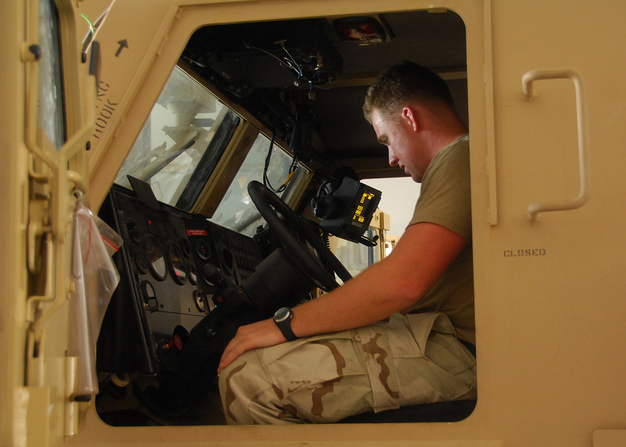 SOUTHWEST ASIA -- Petty Officer 3rd Class Andrew Bourne familiarizes himself with the control panel of a Mine Resistant Ambush Protected Vehicle vehicle during an MRAP on Sep. 4 at an air base in Southwest Asia. The MRAP training course is taught in a joint-service environment to simulate real world experiences military members will encounter while deployed to bases in the U.S. Central Command area of responsibility. The Department of Defense has purchased more than 5,200 MRAP vehicles for servicemembers. Petty Officer Bourne is deployed from the Naval Construction Battalion Center, Port Hueneme, Calif. (U.S. Air Force photo/Tech. Sgt. Raheem Moore)