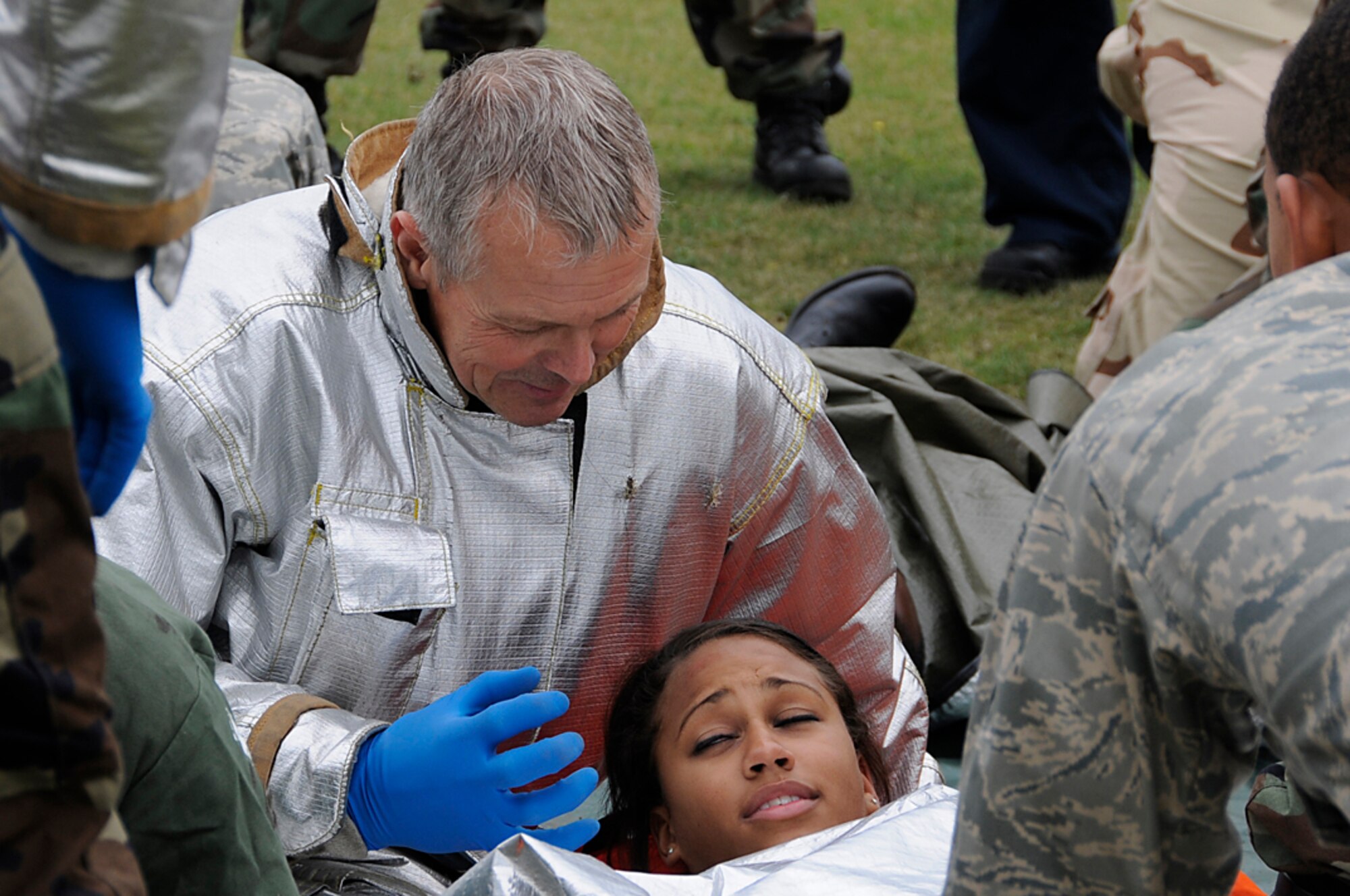 A member of RAF Lakenheath, England's Fire Department talks to a lightning strike victim during a mass casualty exercise, Sept. 11. Emergency personnel talk to disaster victims to keep them conscious and prevent them from going into shock.  (U.S. Air Force photo by Senior Airman Brian J. Ellis)