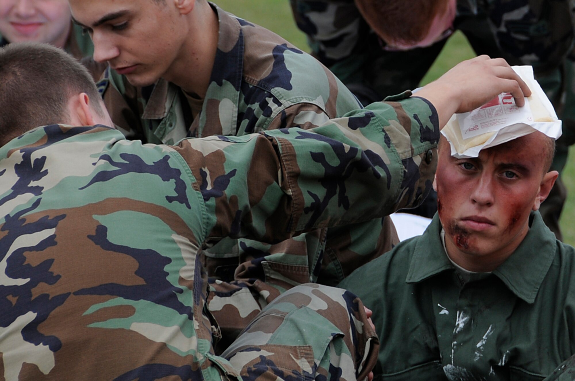 Disaster victims receive treatment from Airmen assisting emergency personnel during a mass casualty exercise at RAF Lakenheath, England, Sept. 11. The Airmen near the scene when the disaster hit had to notify emergency personnel and help clear the victims away from danger.  (U.S. Air Force photo by Senior Airman Brian J. Ellis)