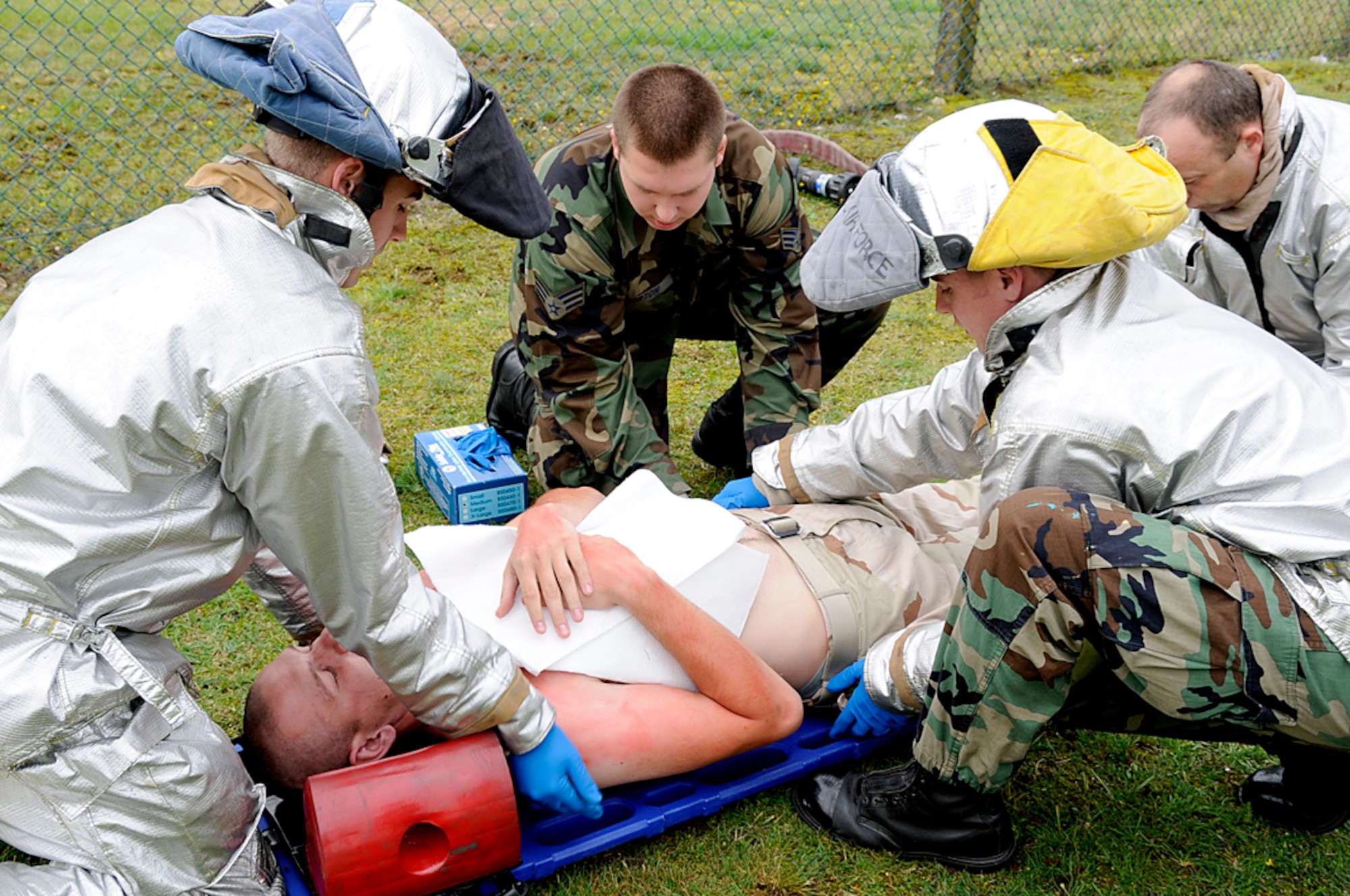 Emergency personnel strap an "injured party" to a stretcher during a mass casualty exercise at RAF Lakenheath, England, Sept. 11. The exercise was used to test the response time of the different organizations during a devastating event. (U.S. Air Force photo by Senior Airman Brian J. Ellis)