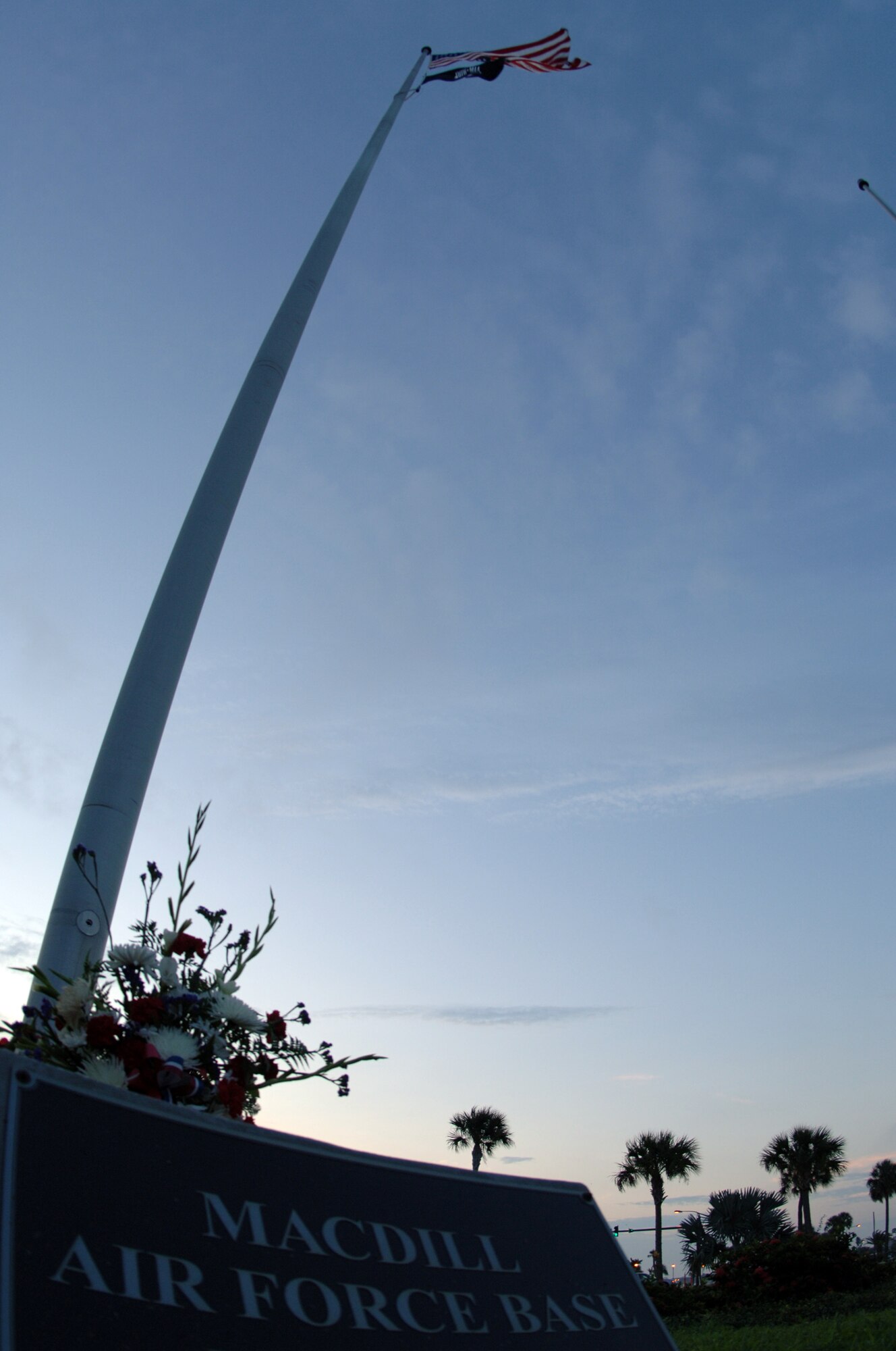 The American Flag accompanied by the POW/MIA Flag waves in the early morning breeze over MacDill Air Force Base Thursday. Members of Team MacDill placed a wreath at the bottom of the flag to commemorate POW/MIA day during the first part of a two part ceremony. Base members will be meeting again during a formal retreat ceremony at the end of the duty day. 