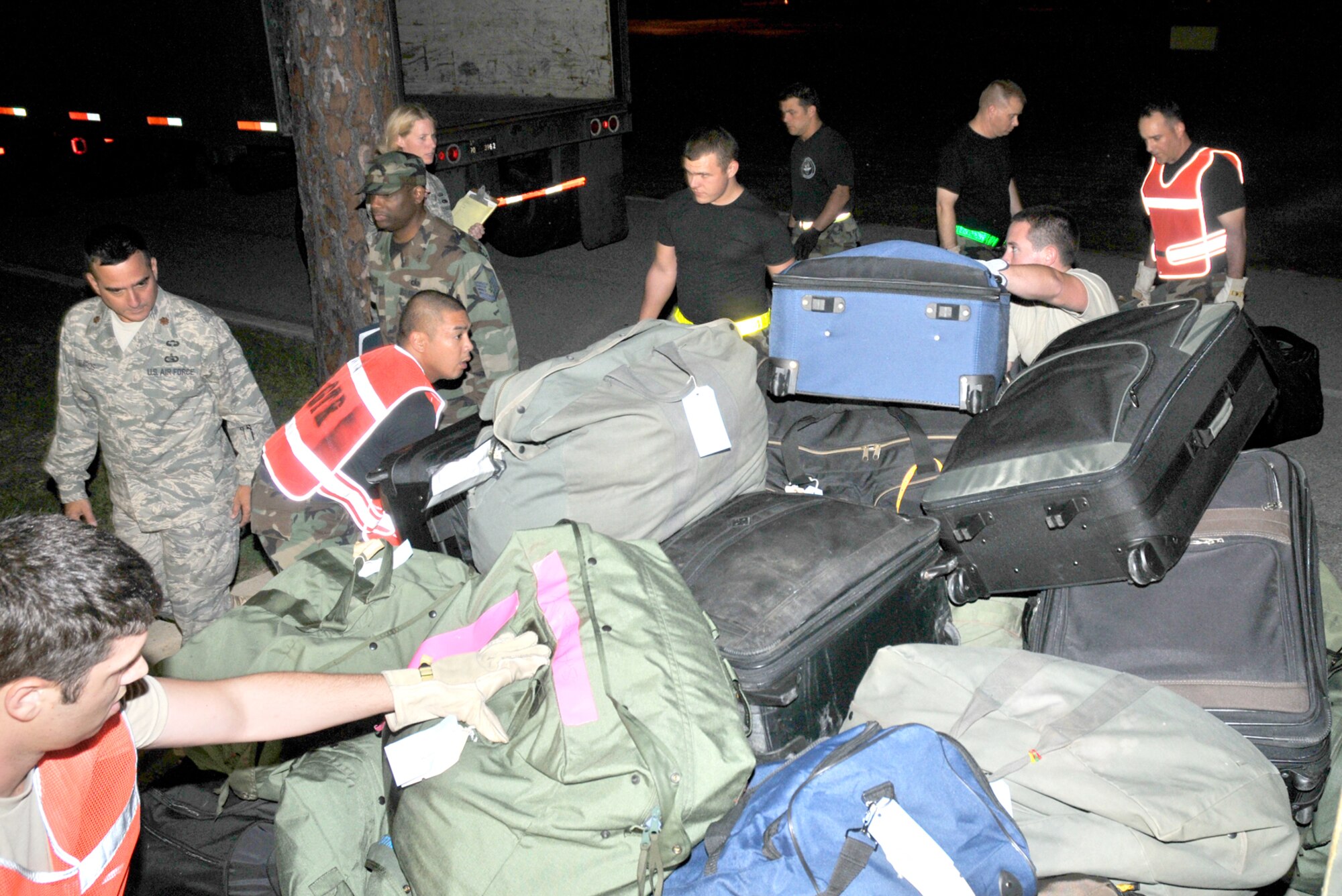 Members of the 81st Training Wing load baggage for 28 airmen who left Keesler Tuesday for deployment to South West Asia.  (U.S. Air Force photo by Adam Bond) 