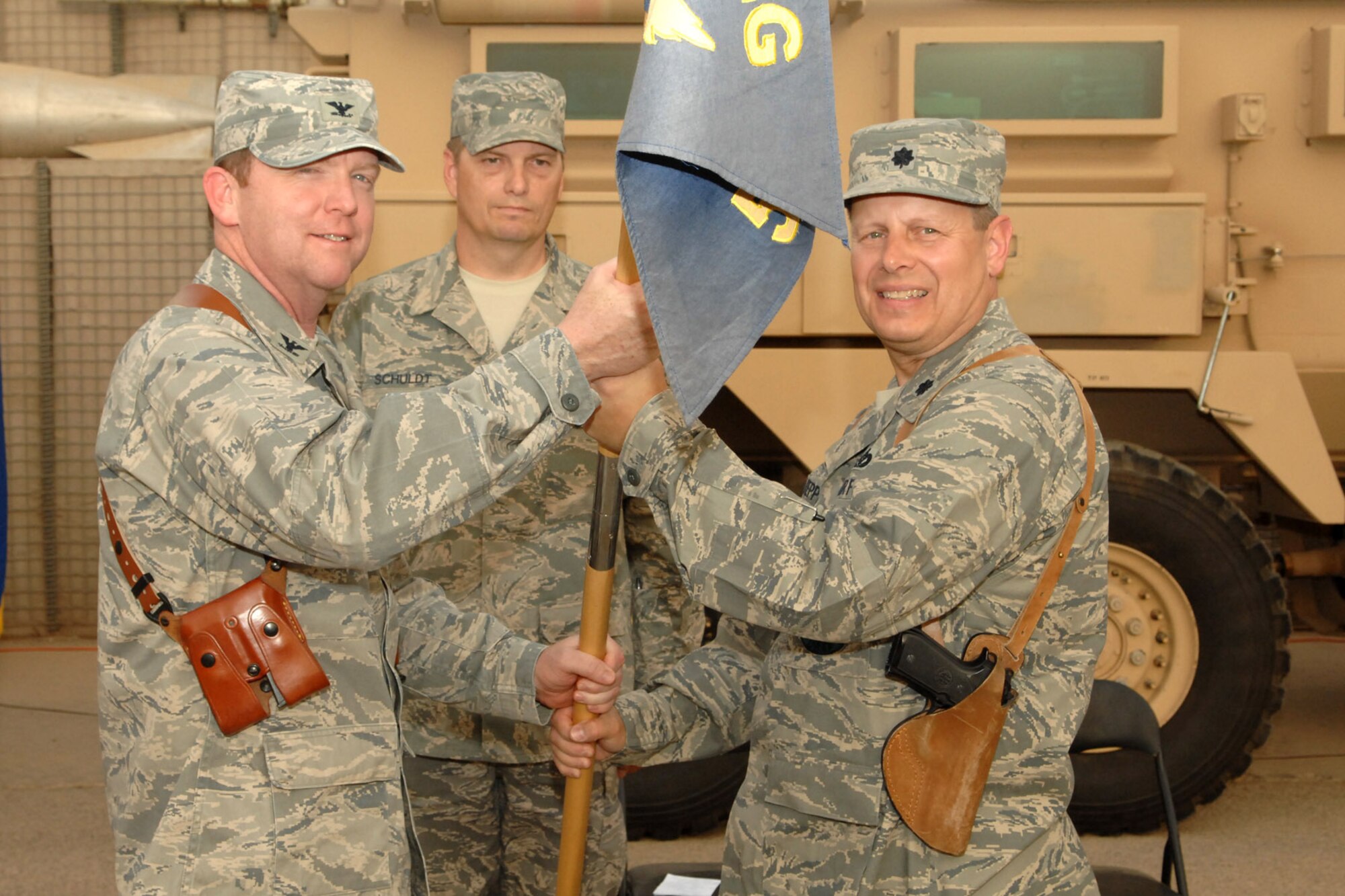 KIRKUK REGIONAL AIR BASE, Iraq -- Lt. Col. Thomas Kuepper, 506th Expeditionary Civil Engineer Squadron commander, accepts the guideon from Col. Richard Scobee, 506th Air Expeditionary Group commander here Sept. 16 after assuming command of the 506 ECES.  Lt Col. Kuepper is deployed from the 445th Civil Engineer Squadron, Wright-Patterson Air Force Base, Ohio.  Lt. Col. Kenneth Evans relinquished command and will return as the 932nd Civil Engineer Squadron commander at Scott Air Force Base, Ill.   (U.S. Air Force photo/Senior Airman Randi Flaugh)