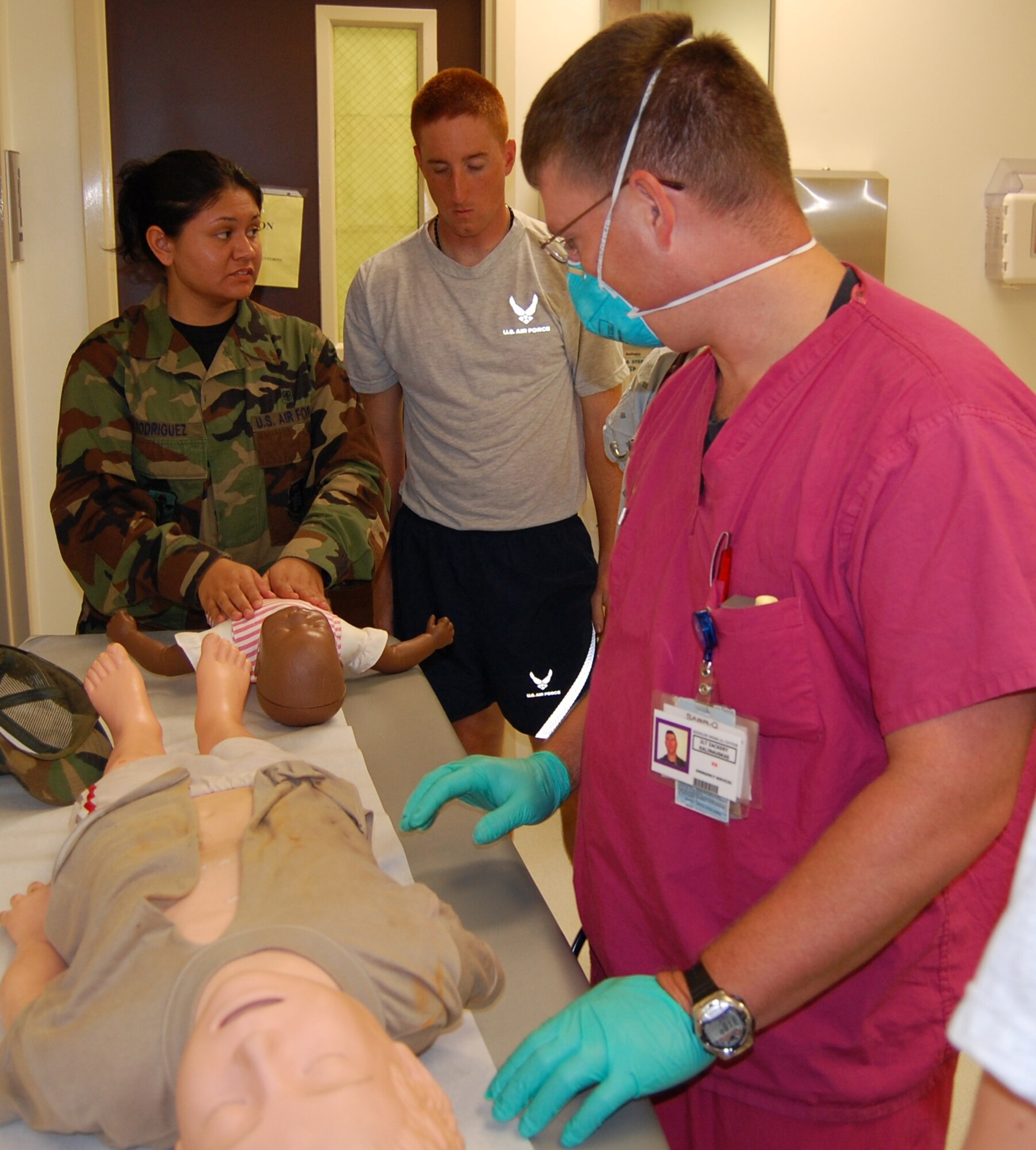 From left, Senior Airman Alyssa Rodriguez, 81st MDG, and Airman Drew Park, 334th TRS, portray parents who brought children to the emergency room to be examined by 2nd Lt. Zackery Kalinauskas, a physician’s assistant.  (U.S. Air Force photo by Steve Pivnick)