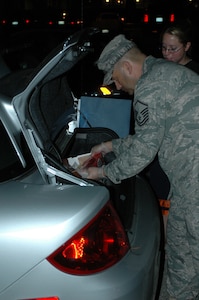 LANGLEY AIR FORCE BASE, Va. -- Master Sgt. Eric McGahey, 1st Logistics Readiness Squadron, inspects the trunk of a vehicle during the no-notice health, safety and morale inspection Sept. 13. The inspection ensured the rooms were free of prohibited items.(U.S. Air Force photo/Master Sgt. Anthony Davis)
