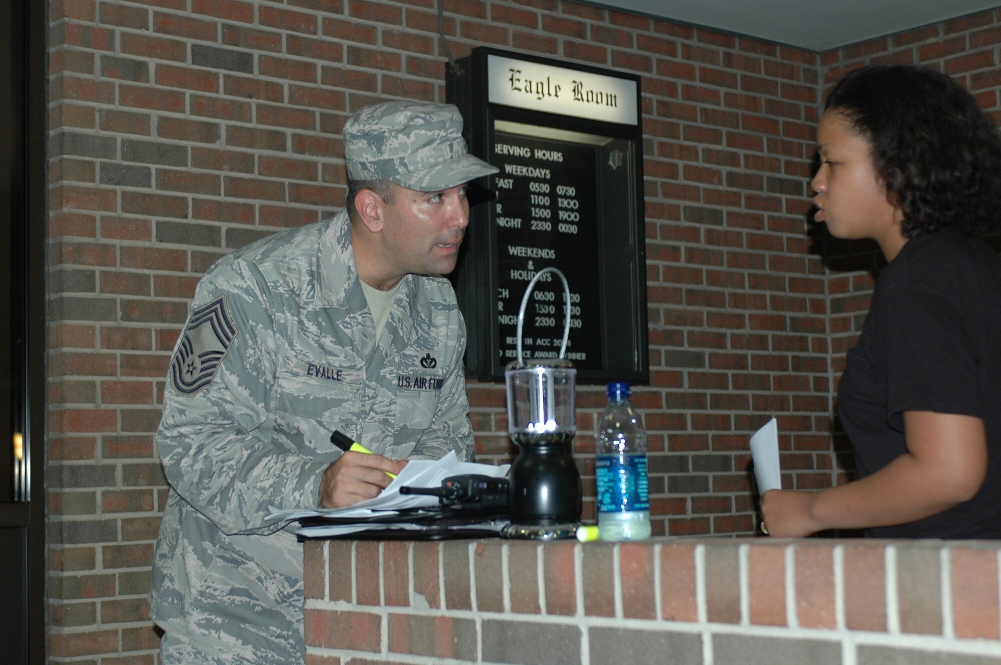 LANGLEY AIR FORCE BASE, Va. -- Chief Master Sgt. John Evalle, 1st Force Support Squadron, signs in an Airman during the no-notice health, safety and morale inspection of Cunningham Hall Sept. 13. The inspection ensured the rooms were free of prohibited items. (U.S. Air Force photo/Master Sgt. Anthony Davis)