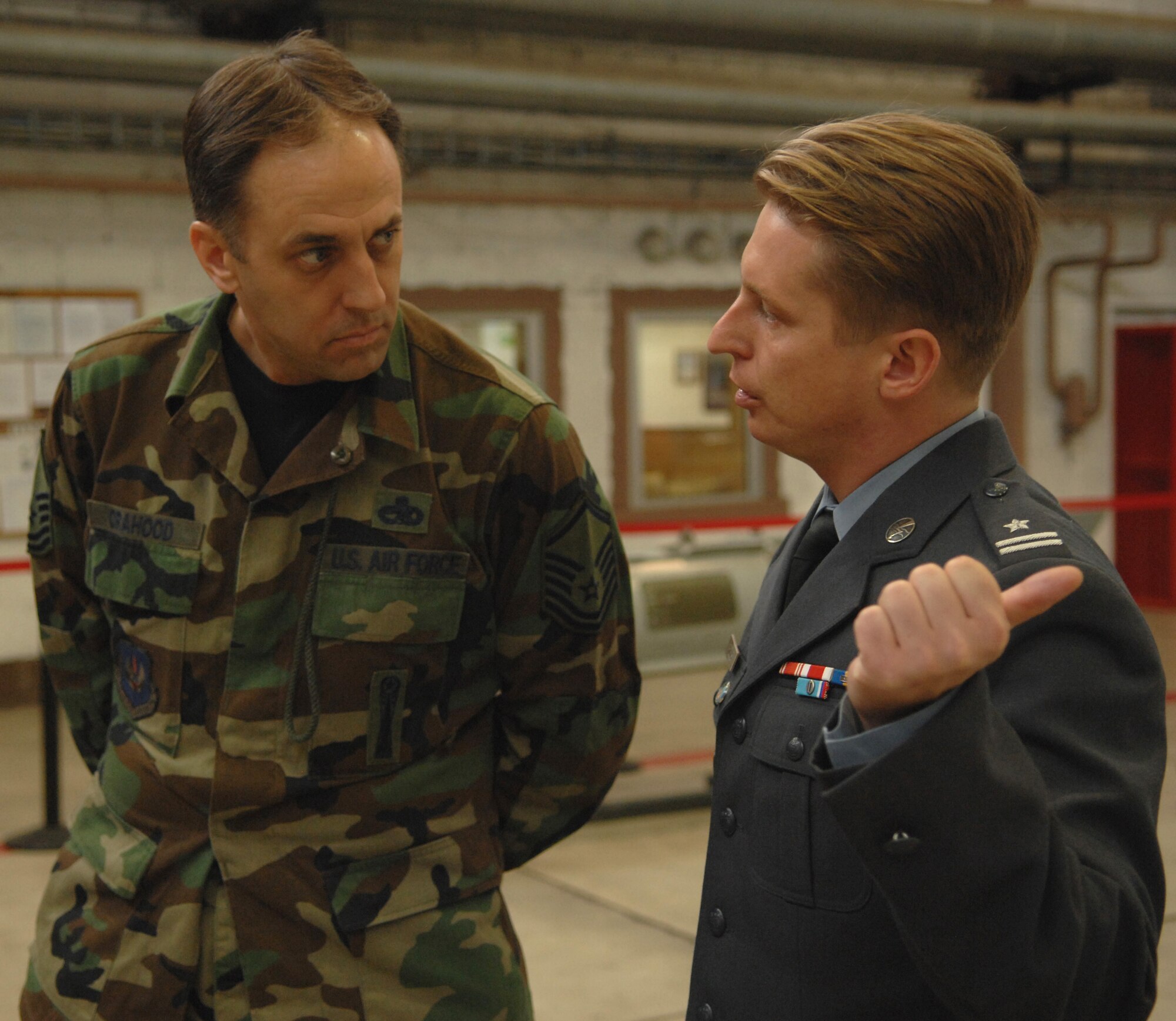 Master Sgt. Allen Orahood, 52nd Maintenance Group loading and standardization crew, discusses the loading and standardization mission with Polish Air Force public affairs officer Maj. Marcin Rogus at Spangdahlem Air Base, Germany, Sept. 16, 2008. The visit to Spangdahlem was part of a U.S. Air Forces in Europe Polish Familiarization visit. (U.S. Air Force photo by Airman 1st Class Nicholas Wilson)