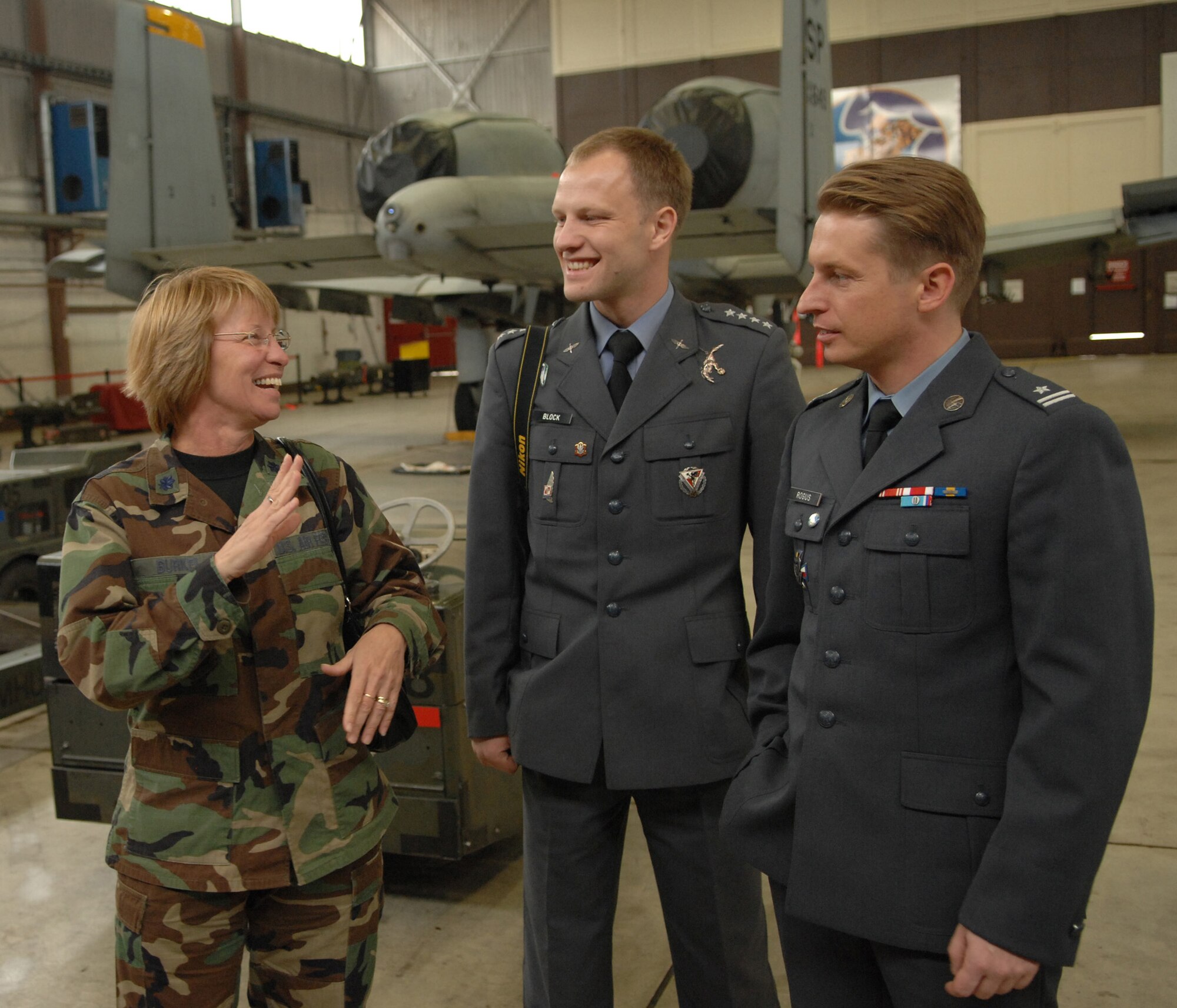 Lt. Col. Audrey Burkel, chief of public affairs, 52nd Fighter Wing, and Polish Air Force public affairs officers Capt. Jakub Block and Maj. Marcin Rogus (far right) visit with 52nd Maintenance Group loading and sanitization crew members at Spangdahlem Air Base, Germany, Sept. 16, 2008. The visit to Spangdahlem was part of a U.S. Air Forces in Europe Polish Familiarization visit. (U.S. Air Force photo by Airman 1st Class Nicholas Wilson) 