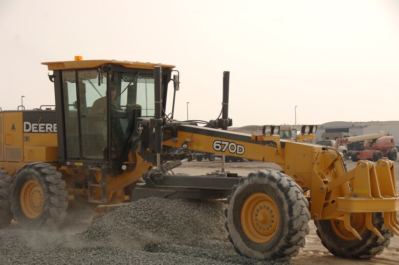 SOUTHWEST ASIA -- Staff Sgt. Shane Newell from the 380th Expeditionary Civil Engineer Squadron uses a Motor Grader to spread fill material used to build up and stabilize the sub-base prior to placing base course material here Sept. 16. The grader is a precision piece of equipment that can level dirt to a 10th of an inch. ECES is preparing an area for war readiness materials in support of Operation Iraqi and Enduring Freedom. Sergeant Newell is deployed from the 735th CES Ramstein Air Base, Germany.(U.S. Air Force photo/Tech. Sgt. Christopher A. Campbell)(released)