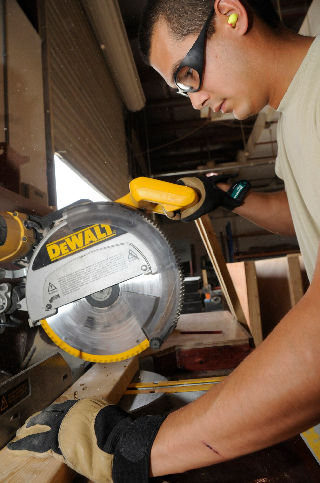 Airman 1st Class Allen Fillingame, structural apprentice assigned to the 379th Expeditionary Civil Engineer Squadron, trims lumber to build a temporary road closed sign Sept. 16, 2008, at an undisclosed air base in Southwest Asia. Airman Fillingame, a native of Charleston, S.C., is deployed from Sheppard Air Force Base, Texas, supporting Operations Iraqi Freedom, Enduring Freedom and Joint Task Force-Horn of Africa. (U.S. Air Force photo by Staff Sgt. Darnell T. Cannady/Released)