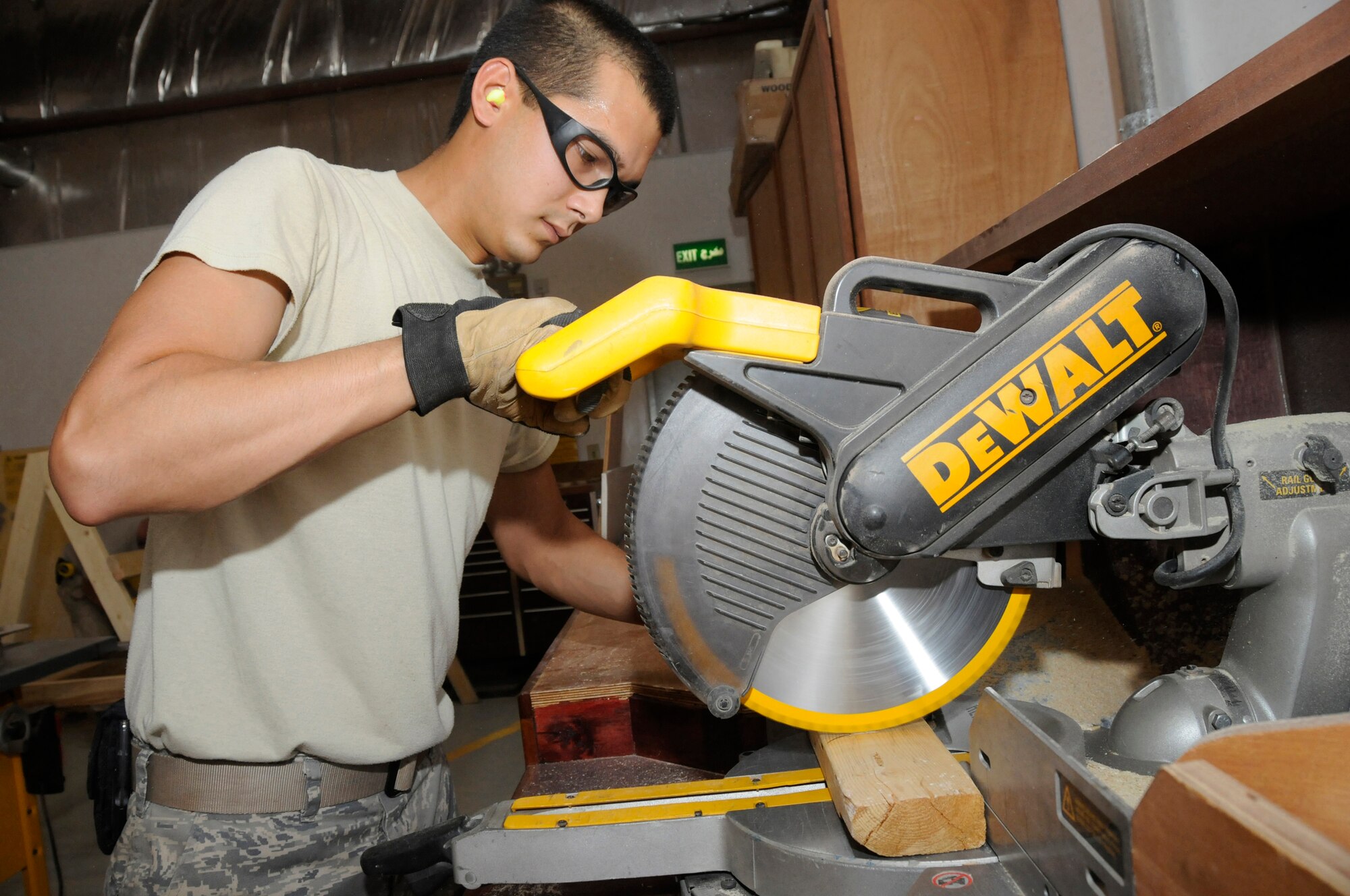 Airman 1st Class Allen Fillingame, structural apprentice assigned to the 379th Expeditionary Civil Engineer Squadron, trims lumber to build a temporary road closed sign Sept. 16, 2008, at an undisclosed air base in Southwest Asia. Airman Fillingame, a native of Charleston, S.C., is deployed from Sheppard Air Force Base, Texas, supporting Operations Iraqi Freedom, Enduring Freedom and Joint Task Force-Horn of Africa. (U.S. Air Force photo by Staff Sgt. Darnell T. Cannady/Released)