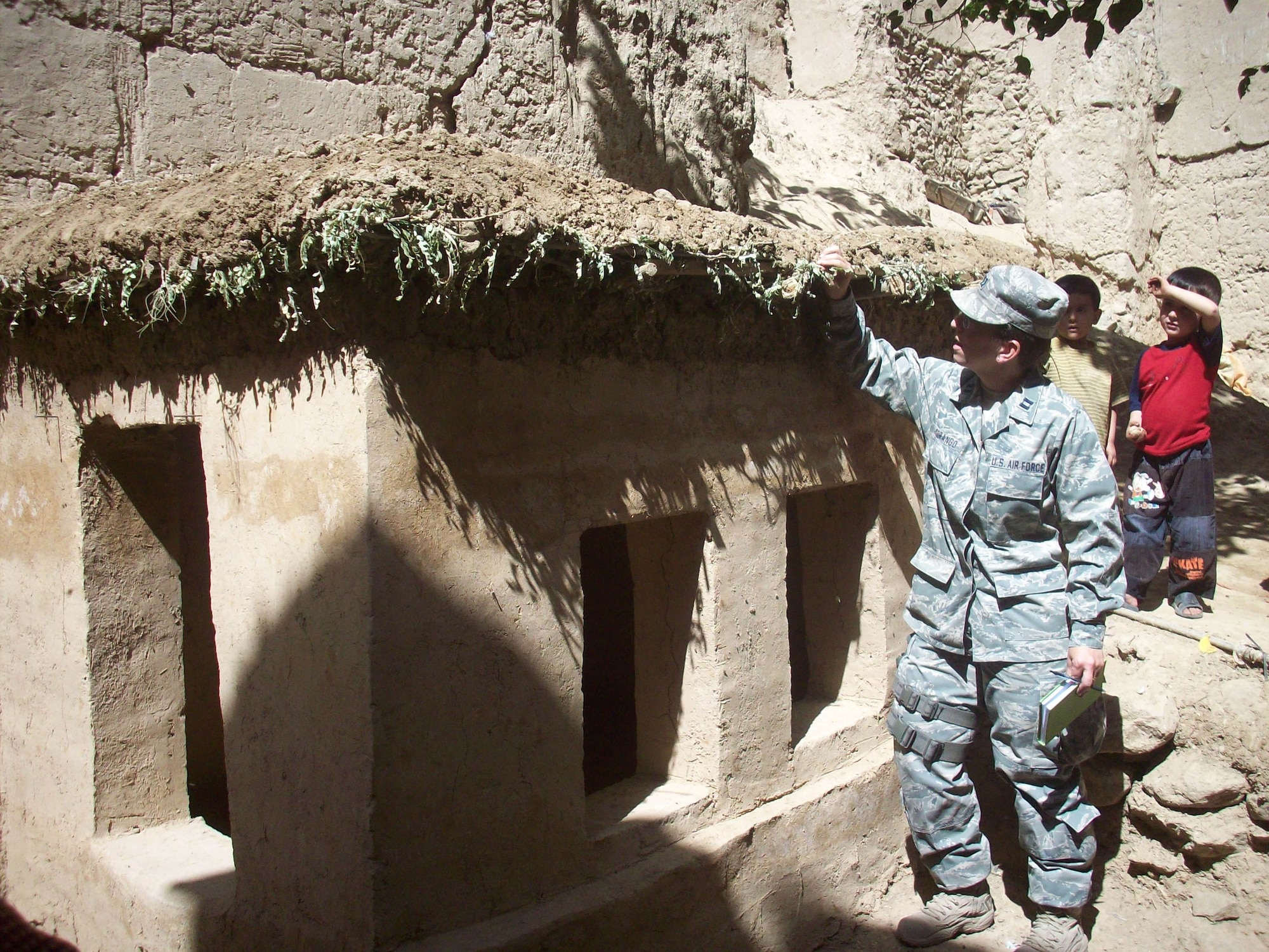 Air Force Capt. Jillian Torango, Panjshir Provincial Reconstruction Team Woman’s Affairs Liaison, checks the status of a chicken coop that is being constructed as part of a women’s poultry training program that has just started in Tawakh village, Anaba District, Afghanistan, Sept. 15.  A team made up of members of MARWA, an Afghan non-governmental organization, the Department of Women’s Affairs, and the Panjshir Provincial Reconstruction Team visited the village to view the progress. More than 30 families are benefiting from this program. (U.S. Air Force photo by Tech. Sgt. Dawn Tiemann)