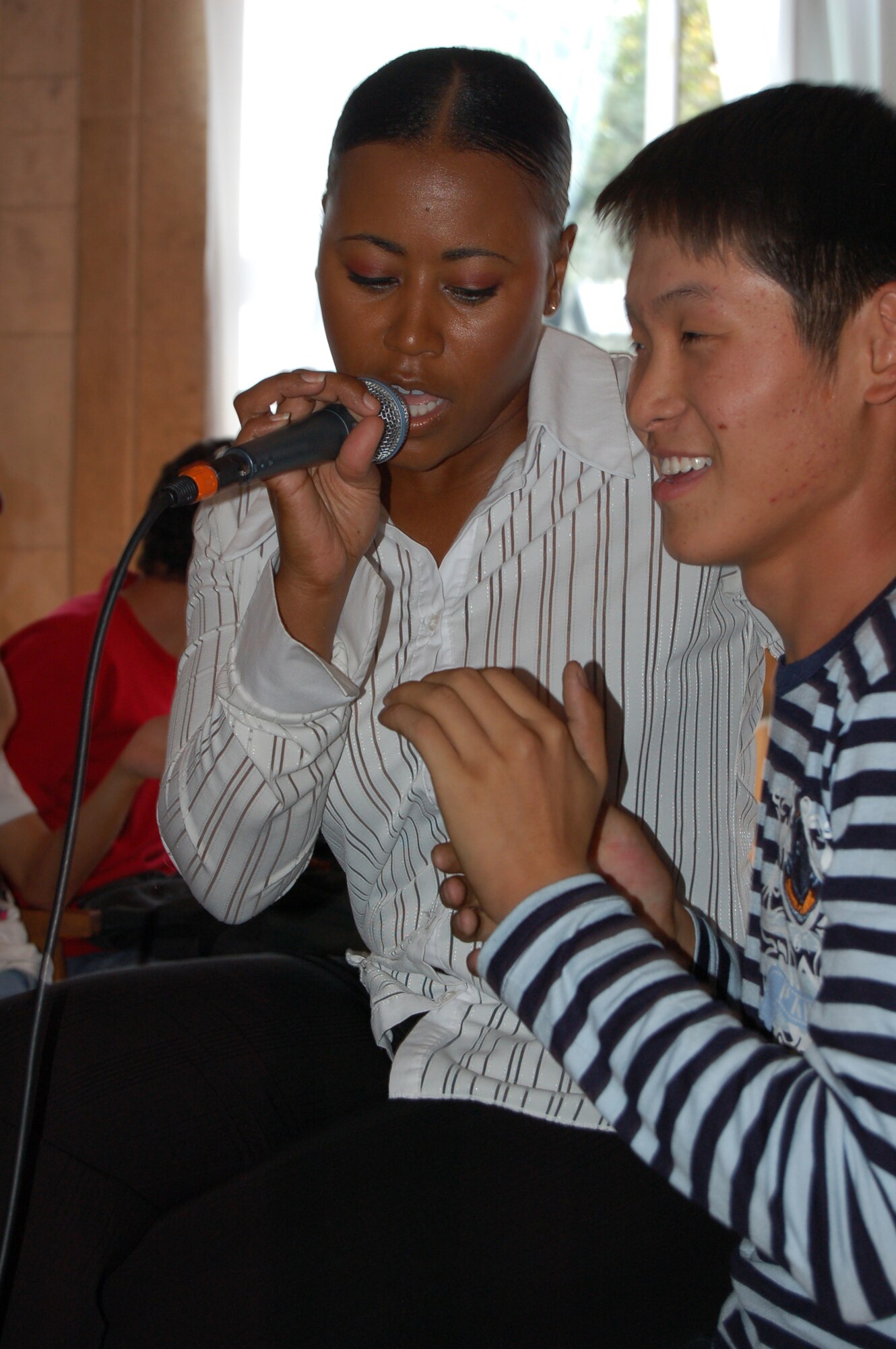 Master Sgt. Regina Coonrod belts out a tune for young Kyrgyz fan at the Bishkek Musical College. During their eight day tour at Manas, the U.S. Air Forces Central Band "Yuma" performed ten concerts at local schools, villages and orphanages, as well as on base for coalition servicemembers. (Air Force photo / Tech. Sgt. Michael Voss)