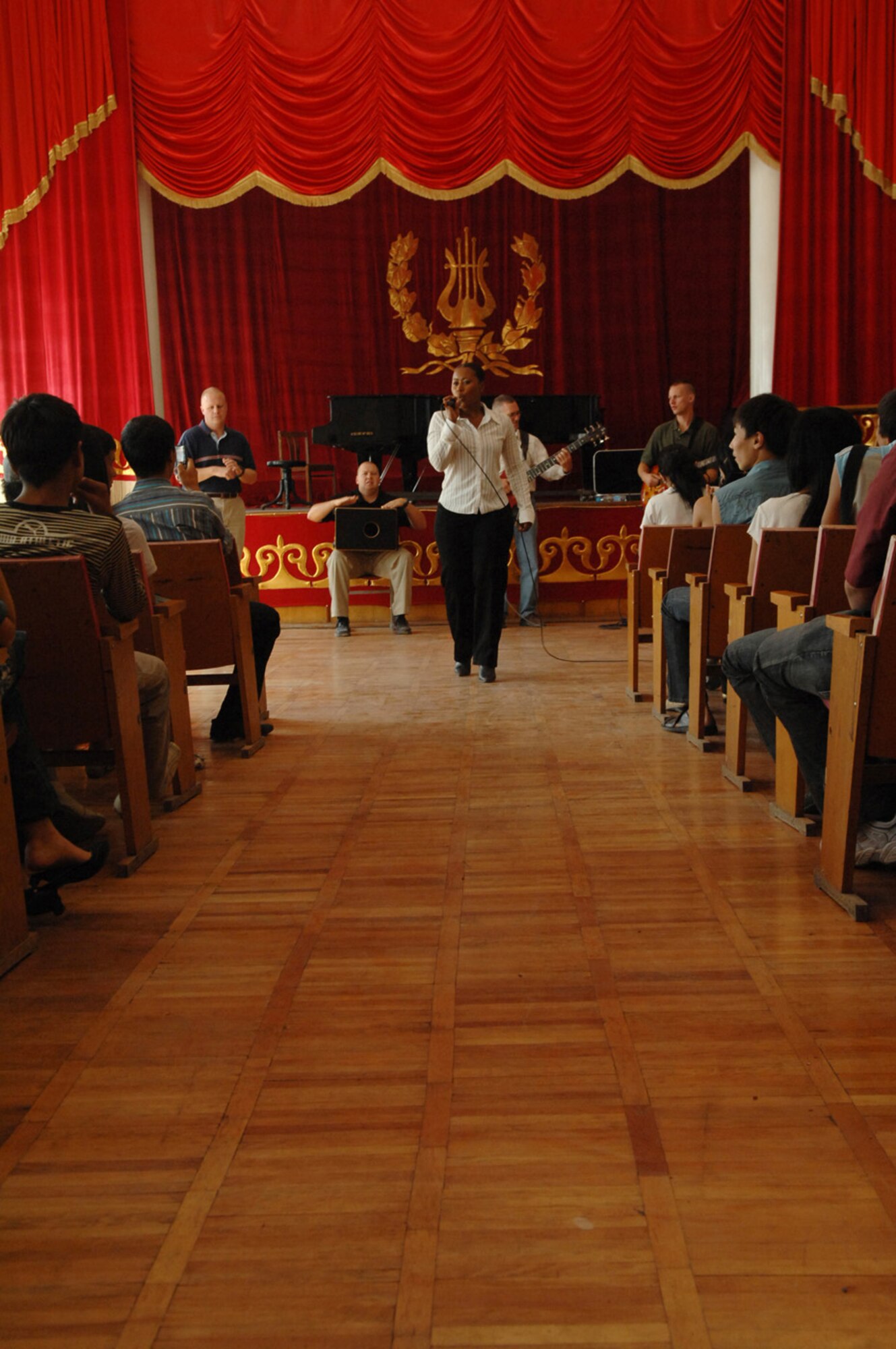 Master Sgt. Regina Coonrod performs in front of nearly 200 students at the Bishkek Musical College. The U.S. Air Forces Central Band "Yuma" performed here during their eight day tour at Manas where they performed ten concerts at local schools, villages and orphanages, as well as on base for coalition servicemembers. (Air Force photo / Tech. Sgt. Michael Voss)