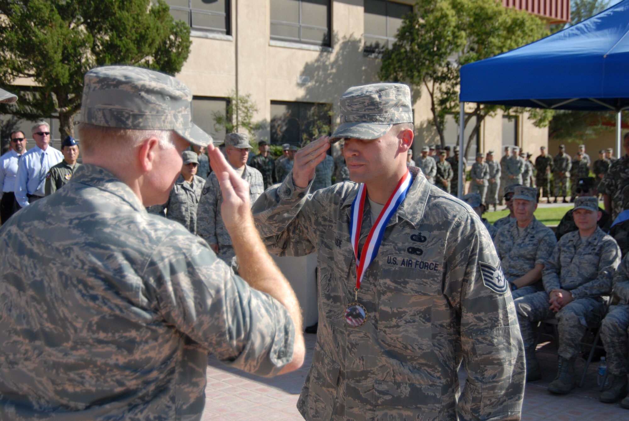 Col. Jerry Gandy, 95th Air Base Wing commander, returns a salute to an Airman during the retreat ceremony held in front of the Air Force Flight Test Center Sept. 18 in honor of 10 servicemembers and two civilians who have recently returned from an overseas deployment. The ceremony also marked the 61st anniversary of the inception of the U.S. Air Force. (Air Force photo by Airman 1st Class William O’Brien)