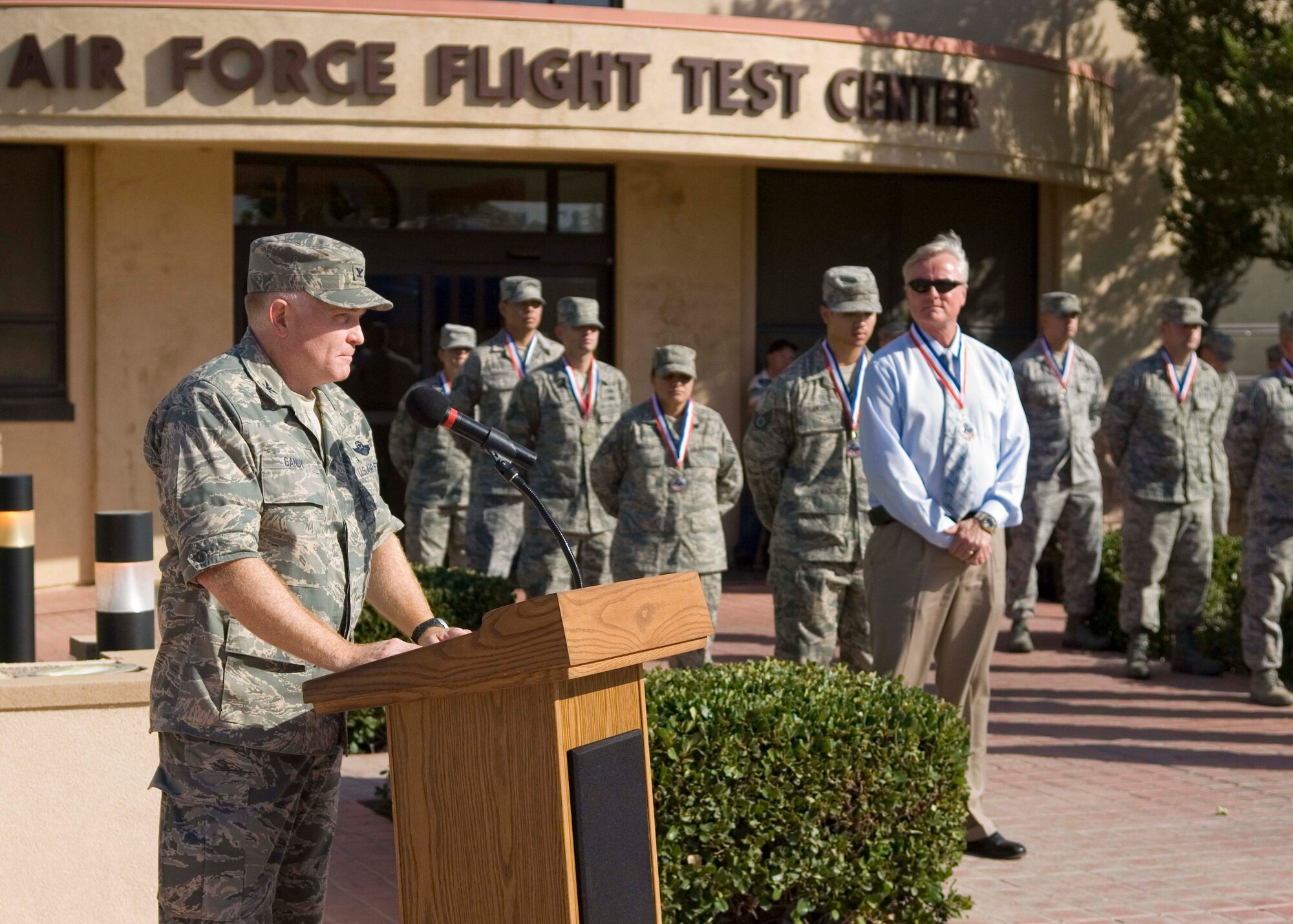 Col. Jerry Gandy, 95th Air Base Wing commander, addresses the audience during a retreat ceremony in front of the Air Force Flight Test Center Sept. 18 in honor of 10 servicemembers and two civilians who have recently returned from an overseas deployment and to mark the 61st anniversary of the inception of the U.S. Air Force. (Air Force photo by Mike Cassidy)