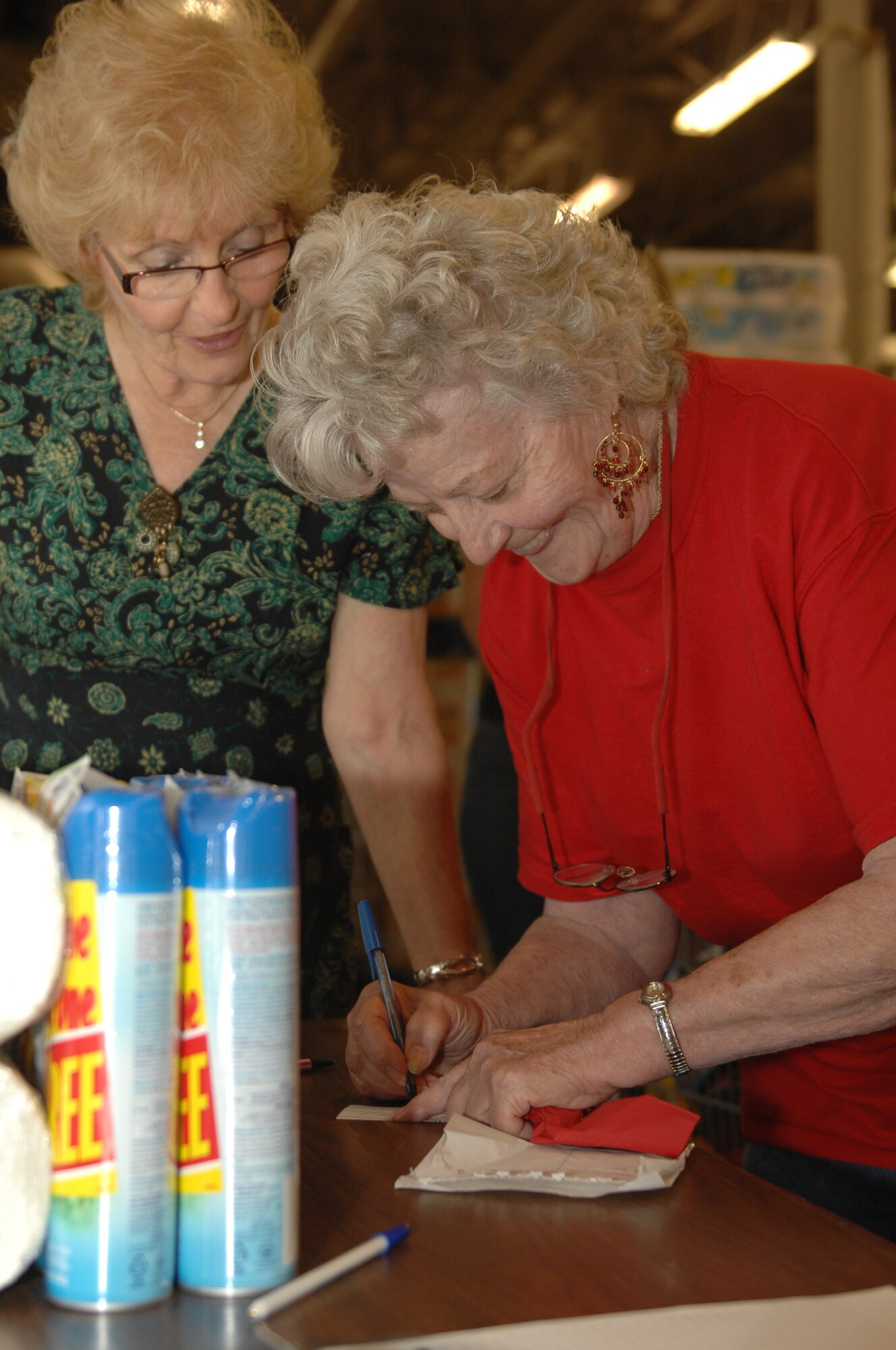 (Left to right) Carol Cummings, retired 28th Bomb Wing secretary of 19 years, helps Betty West, spouse of retired Staff Sgt. David West, sign up for a Retiree Appreciation Day drawing in the commissary, Sept. 19. The drawing was held at the Dakota's Club during a luncheon, which featured chances to win prizes sponsored by both the base exchange and commissary. (U.S. Air Force photo/Airman 1st Class Joshua J. Seybert)
