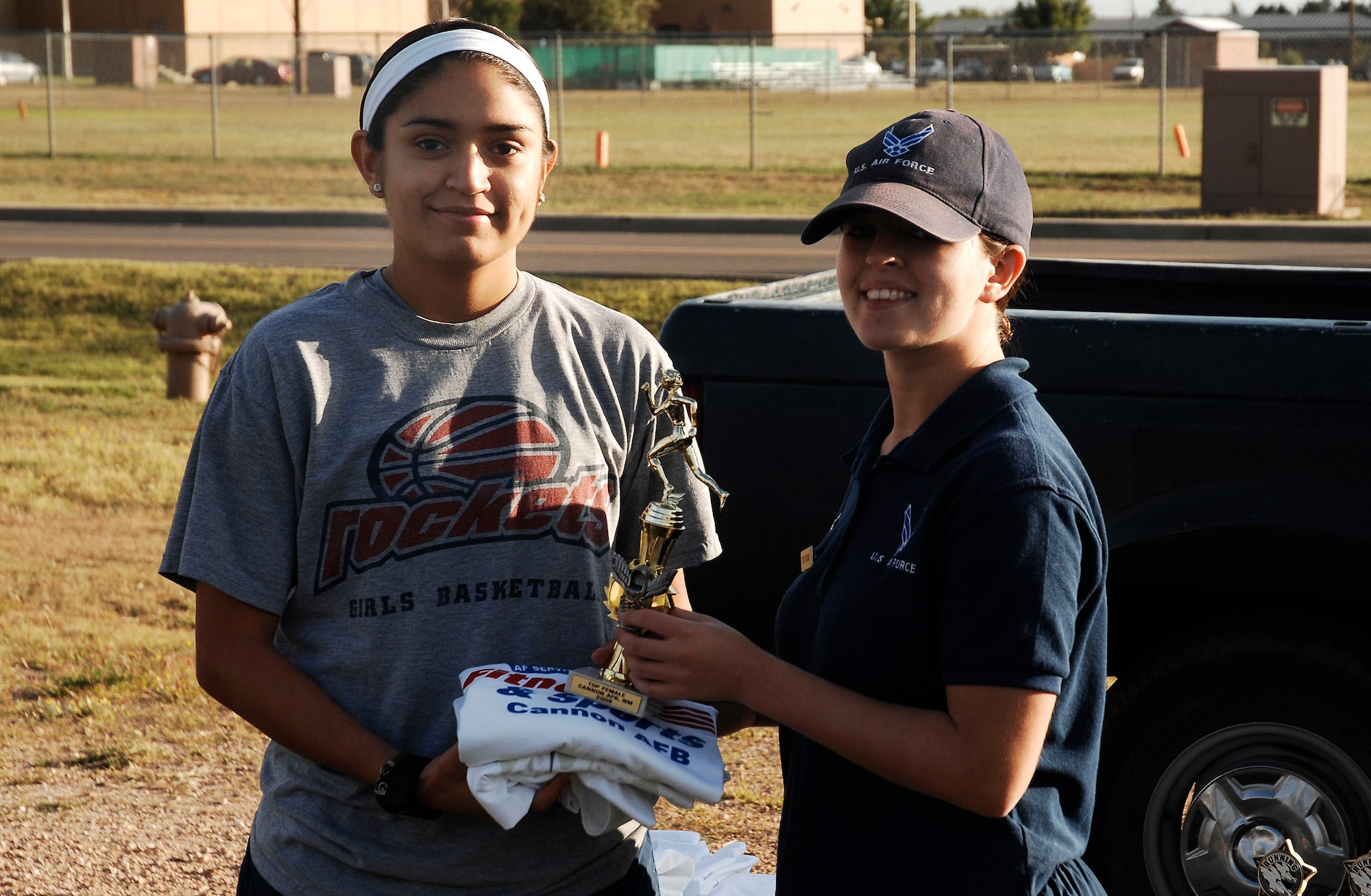 CANNON AIR FORCE BASE, N.M. -- Airman 1st Class Evelyn Chavez, 27th Special Operations Wing, won first place for the women's 100-meter dash with a time of 13.2 seconds Sept. 18. Staff Sgt. Helen Wiggins, 27th Special Operations Services Squadron, presented the awards to the winners. (U.S. Air Force photo/Senior Airman Liliana Moreno)