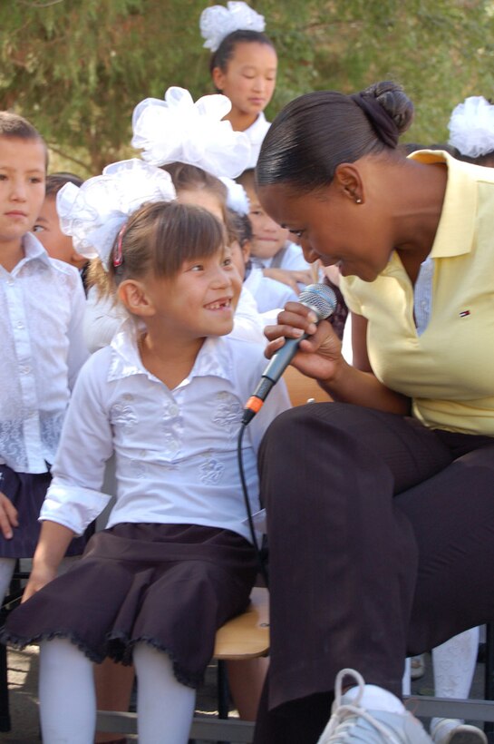 Master Sgt. Regina Coonrod sings to a girl during a Sept. 9 visit to a boarding school at Nizhanchuisk, Krygyzstan. The U.S. Air Force central Band Yuma performed there during their eight-day tour where they played at six schools, villages and orphanages and four concerts on base. (U.S. Air Force photo/Senior Master Sgt. Patrick McCracken) 
