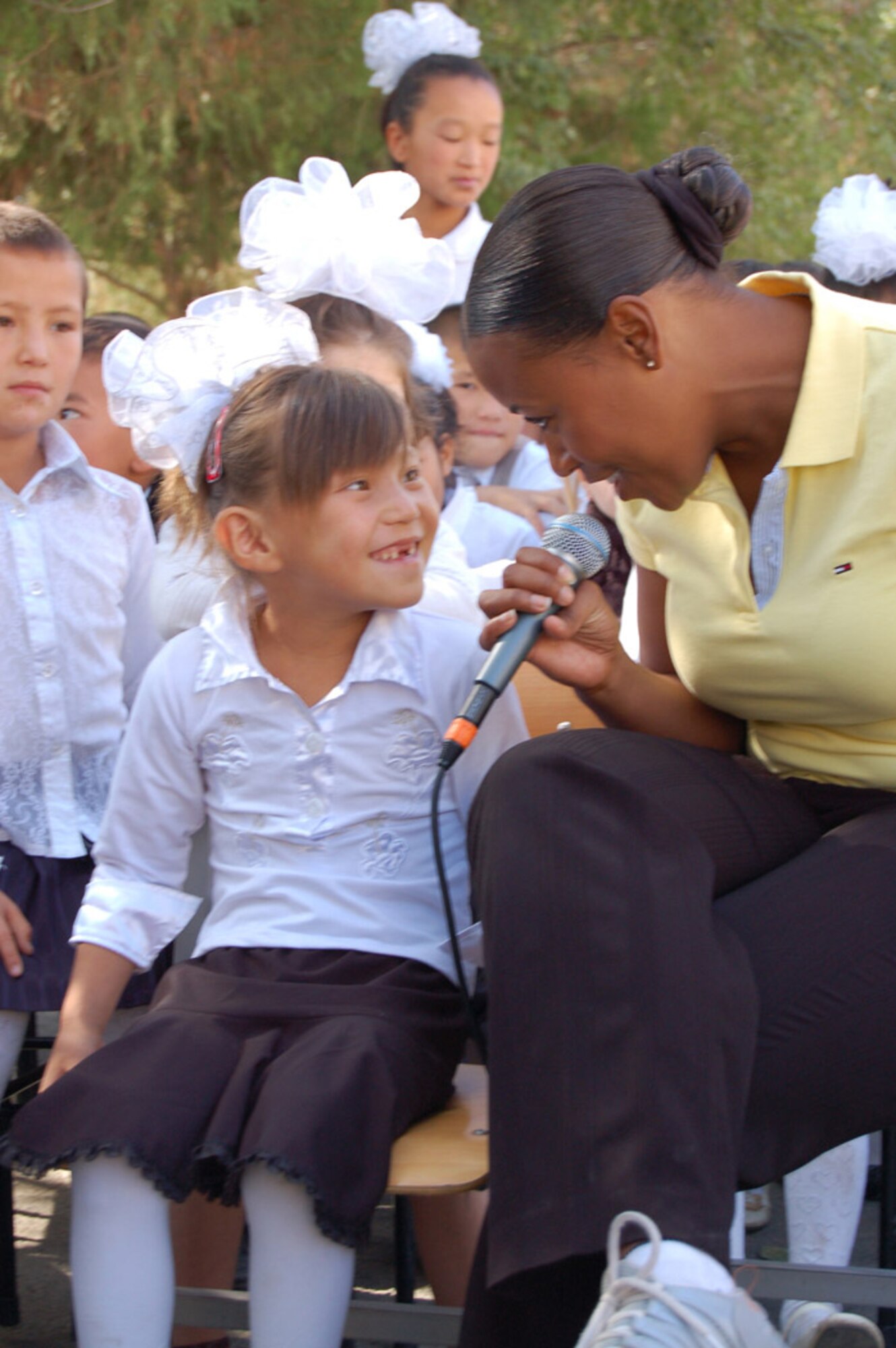 Master Sgt. Regina Coonrod sings to a girl during a Sept. 9 visit to a boarding school at Nizhanchuisk, Krygyzstan. The U.S. Air Force central Band Yuma performed there during their eight-day tour where they played at six schools, villages and orphanages and four concerts on base. (U.S. Air Force photo/Senior Master Sgt. Patrick McCracken) 