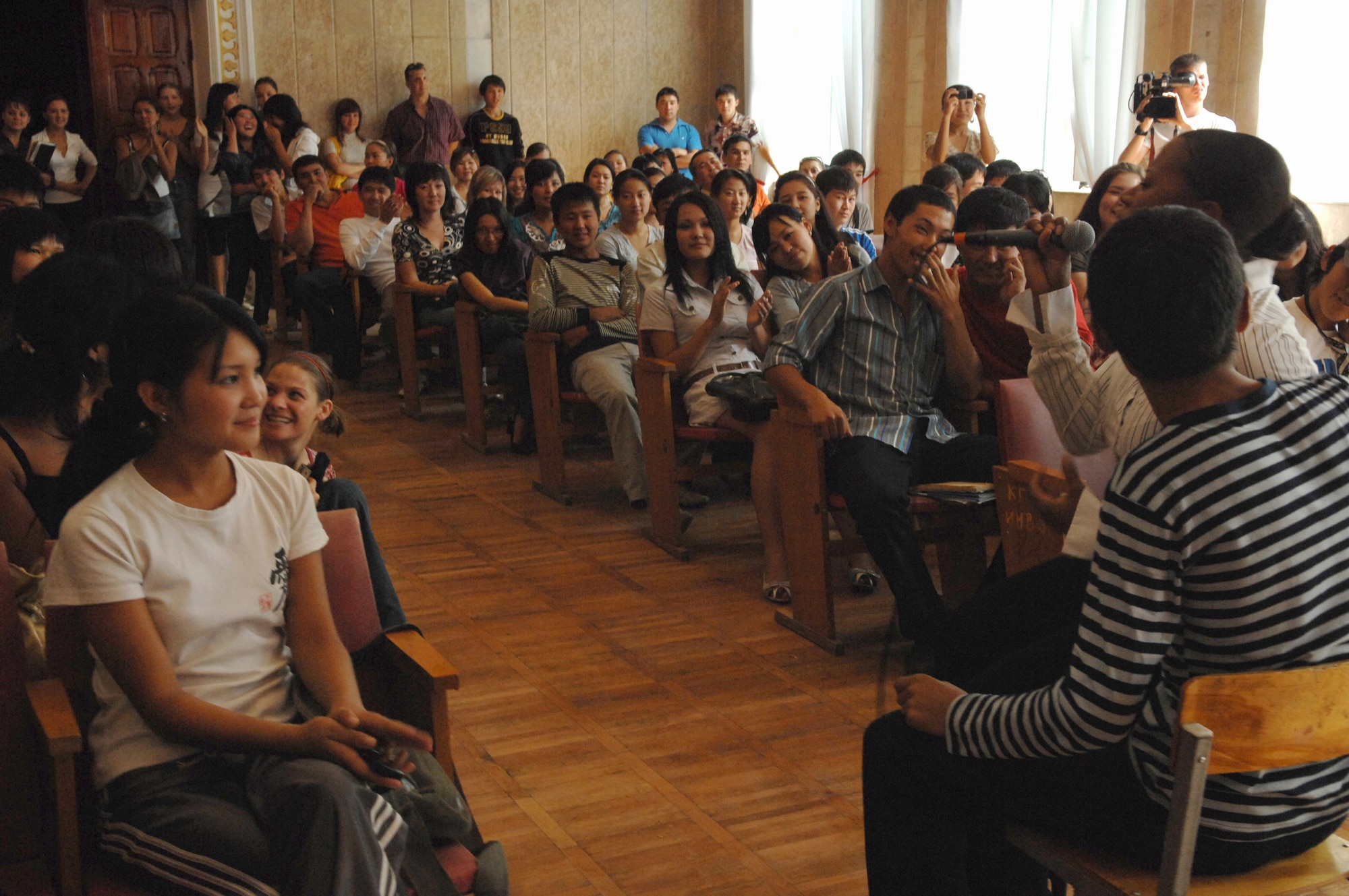 Master Sgt. Regina Coonrod performs a duet with a Kyrgyz boy in front of nearly 200 students Sept. 10 at the Bishkek Musical College in Krygyzstan. During their eight-day tour at Manas, the U.S. Air Forces Central Band Yuma performed 10 concerts at local schools, villages and orphanages, as well as on base for coalition servicemembers. ((U.S. Air Force photo/Tech. Sgt. Michael Voss) 
