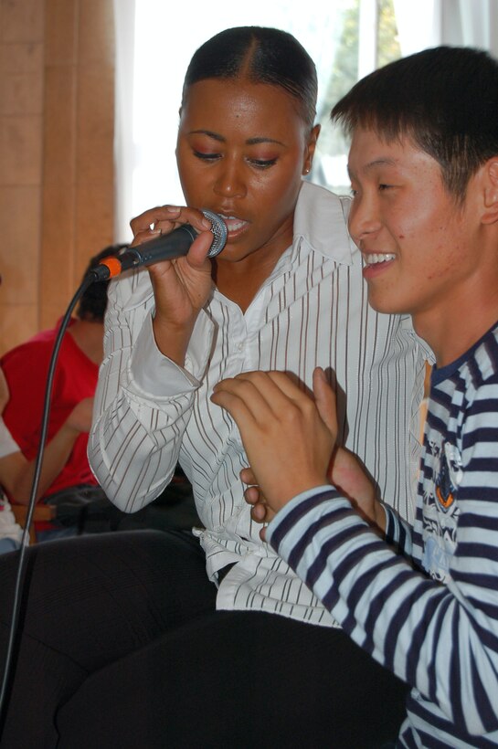 Master Sgt. Regina Coonrod belts out a tune for Kyrgyz fan Sept. 10 at the Bishkek Musical College in Krygyzstan. During their eight-day tour at Manas, the U.S. Air Forces Central Band Yuma performed 10 concerts at local schools, villages and orphanages, as well as on base for coalition servicemembers. ((U.S. Air Force photo/Senior Master Sgt. Patrick McCracken) 
