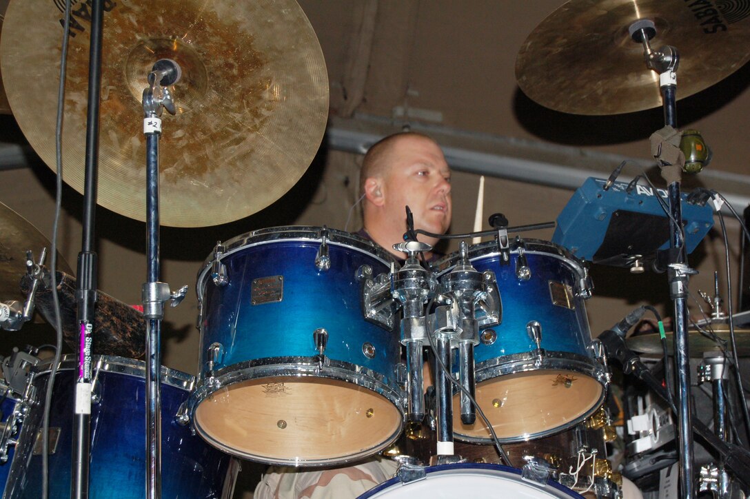 Tech. Sgt. Robert Smith performs a crowd pleasing drum solo of Led Zepplin's "Moby Dick" that brought the crowd to their feet during a Sept. 10 concert at a morale and recreation center on Manas Air Base, Krygyzstan. The U.S. Air Forces Central Band Yuma performed there during their eight-day tour where they played at six schools, villages and orphanages and four concerts on base. (U.S. Air Force photo/Senior Master Sgt. Patrick McCracken) 

