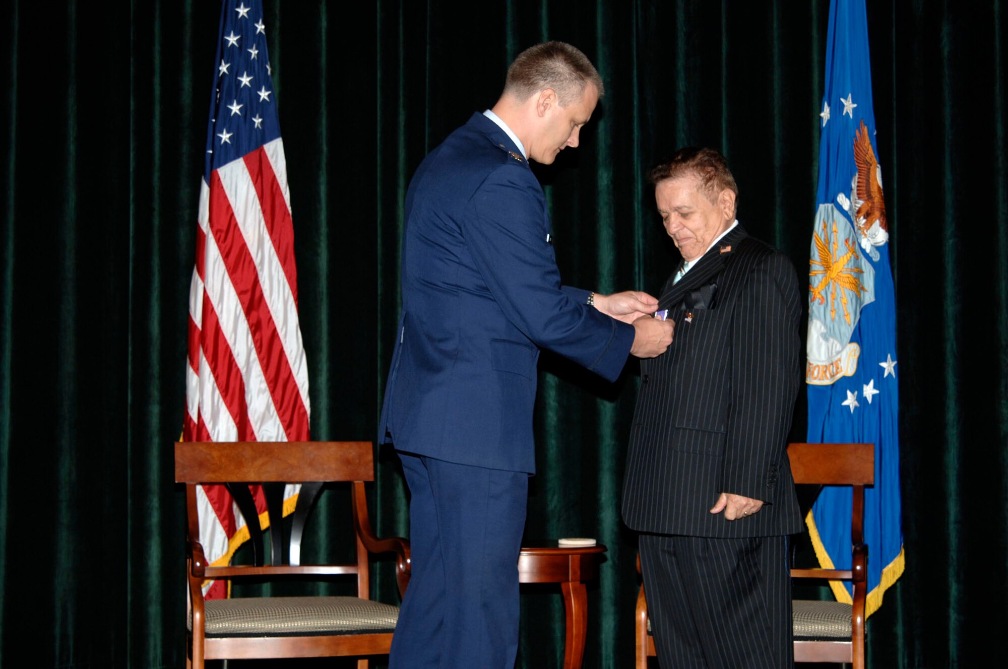 Col. Matthew Arens, 6th Air Mobility Wing Vice commander, pins the Purple Heart Medal on Senior Master Sergeant (Ret) William Colon during a ceremony at the Davis Conference Center Sept. 12. Sergeant Colon received his Purple Hear after waiting 57 years. He earned his medal when his Jeep was hit by an SS officer who did not realize WWII was over, in 1951. (U.S. Air Force photo by Staff Sgt. Ronnie Hill)


