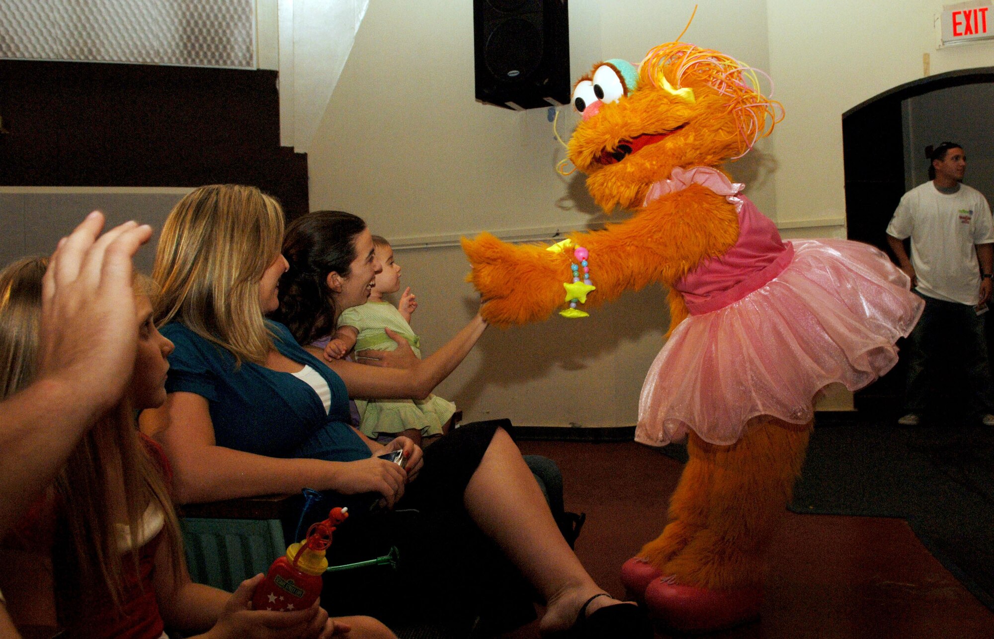 Sesame Street character Zoe exchanges high-fives with MacDill Air Force Base auidence members during a live performance at the Base Theater Sept. 13. Seseame Street live is sponsored by the USO and Sesame Workshop to create a dialog between children and parents about the challenges of deployment, homecomings and changes in parents. (U.S. Air Force photo by Senior Airman Rachel Cunningham)