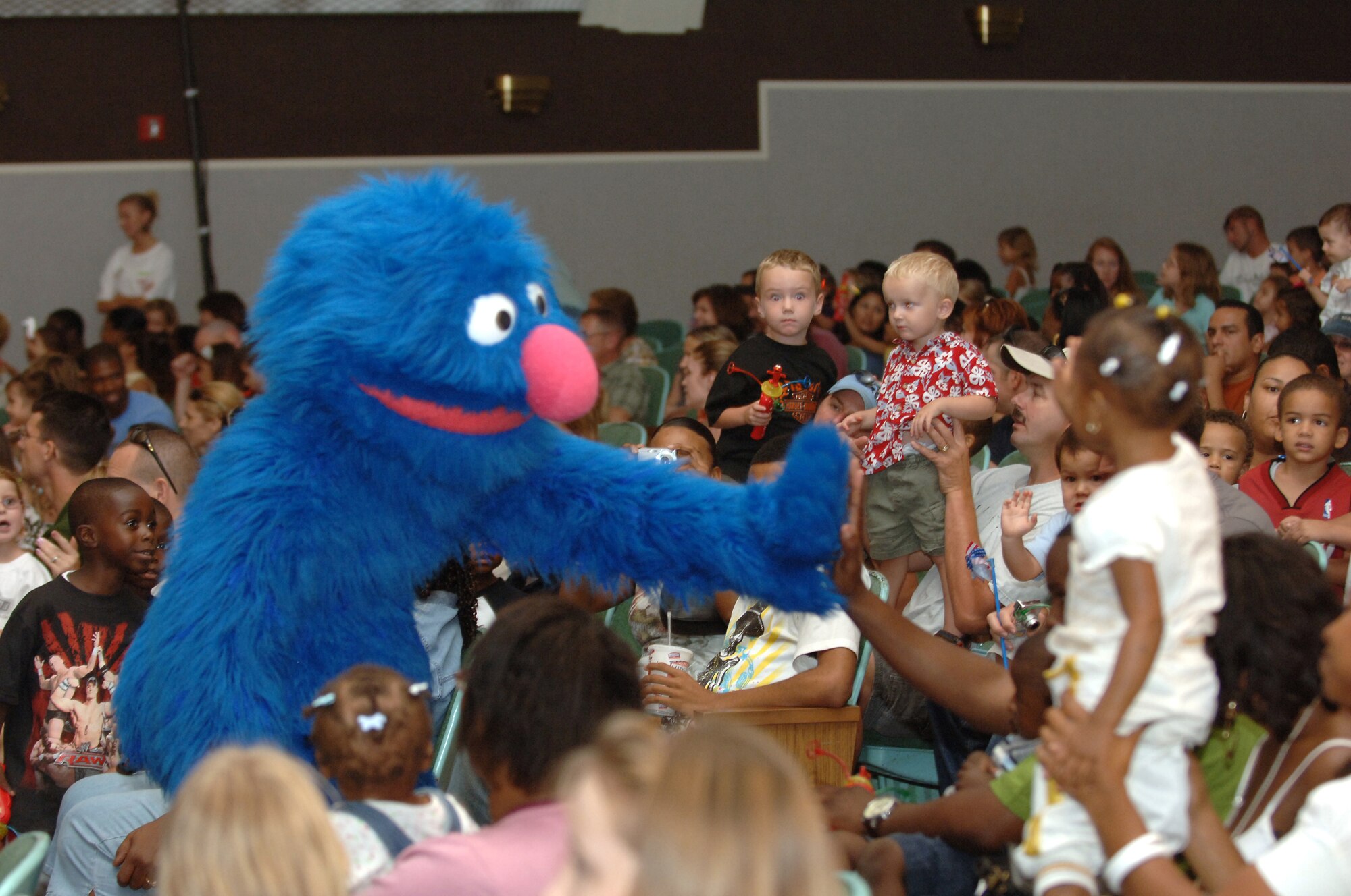 Sesame Street character Grover greets the MacDill crowd during a live performance Sept. 13 at the Base Theater. Children and parents alike were entertained, and got to mingle with the furry creatures of television and film fame. (U.S. Photo by Senior Airman Rachel Cunningham)