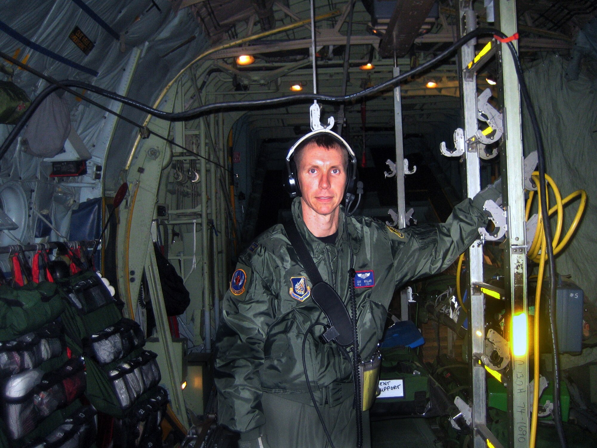 Capt. Sam Millar stands ready during a recent medical evacuation mission. Captain Millar was called upon to provide medical assistance during an Aug. 29 emergency aboard an Air Canada flight from Narita, Japan, to Toronto. He is assigned to the 18th Aeromedical Evacuation Branch. (Courtesy photo) 
