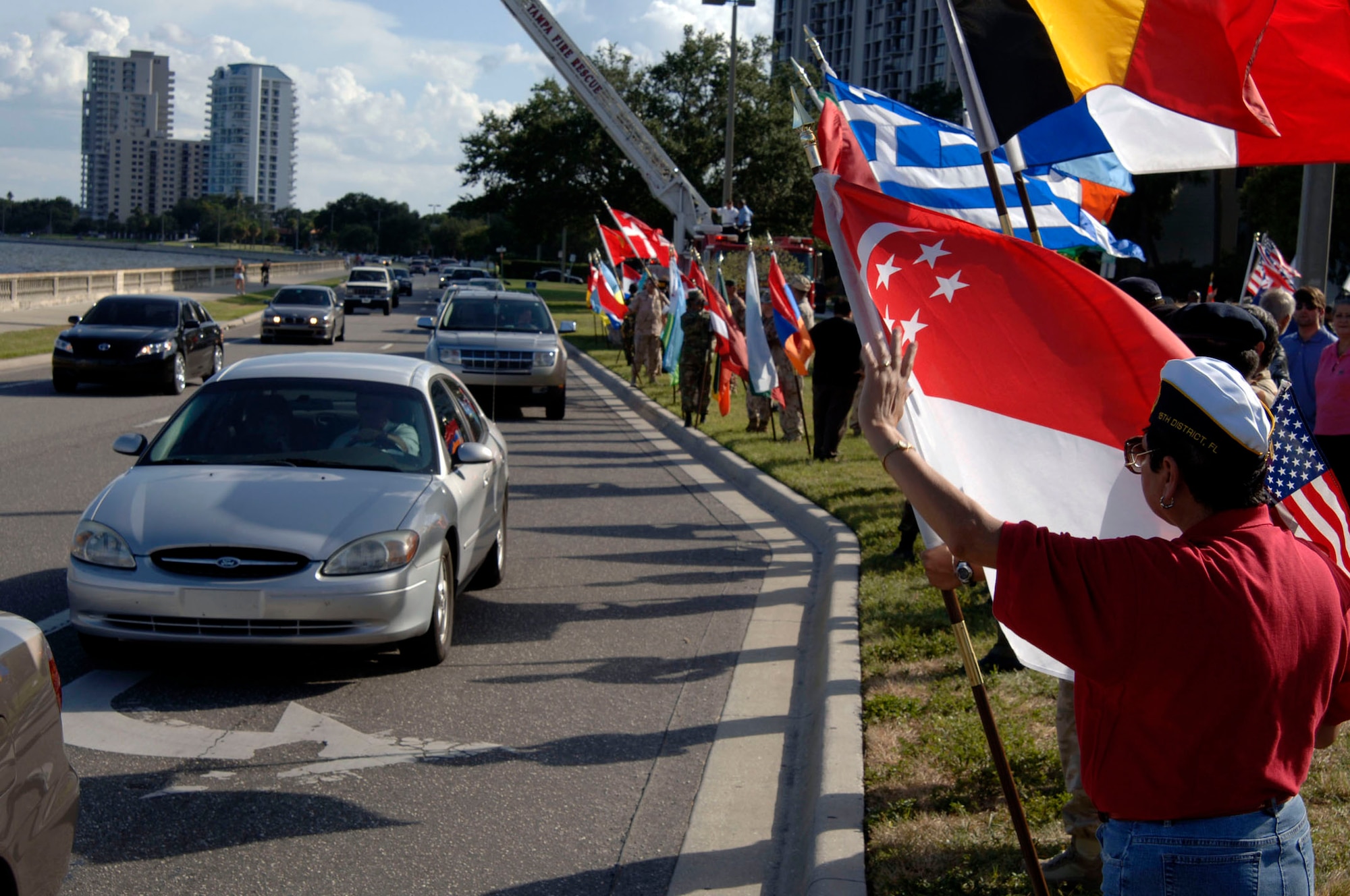 Members of the Bayshore Patriots, a Tampa community group, along with liaison officers from the 64 different nations attached to U.S. Central Command's Coalition Village, greeted Bayshore Boulevard drivers Sept. 12, the day after Patriots Day to show support and solidarity. Sept. 12 is the anniversary of the invoking of Article 5 by NATO, which states that an attack on one member country is an attack on all. 
(U.S. Air Force Photo by Staff Sgt. Ronnie Hill) 